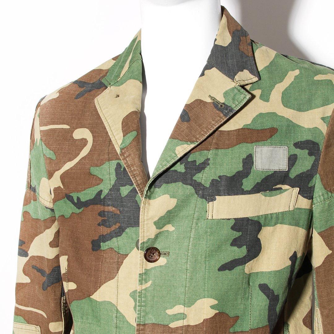 Camouflage jacket by Junya Watanabe for Comme des Garcons
Green tones 
Button-front closure 
Three front pockets 
Long sleeve 
Notched collar 
Button cuff closure 
Patch details 
Made in Japan 
Condition: Excellent, little to no visible wear. (see