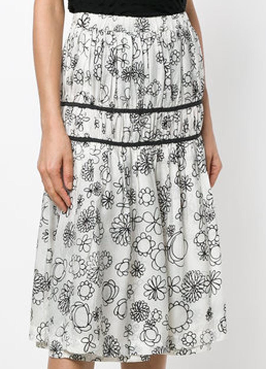 Comme des Garcons CDG printed fluid skirt featuring a white with a contrasting floral black print all over, this feminine midi skirt presents a gathered design in its straight fit. With an elasticated high rise, it features a straight straight hem..