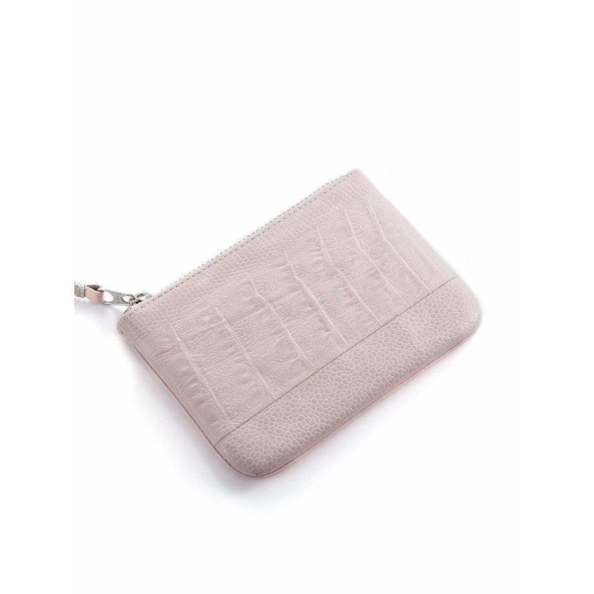 Pink crocodile-effect embossed leather coin purse with zipper closure from Comme des Garçons. 