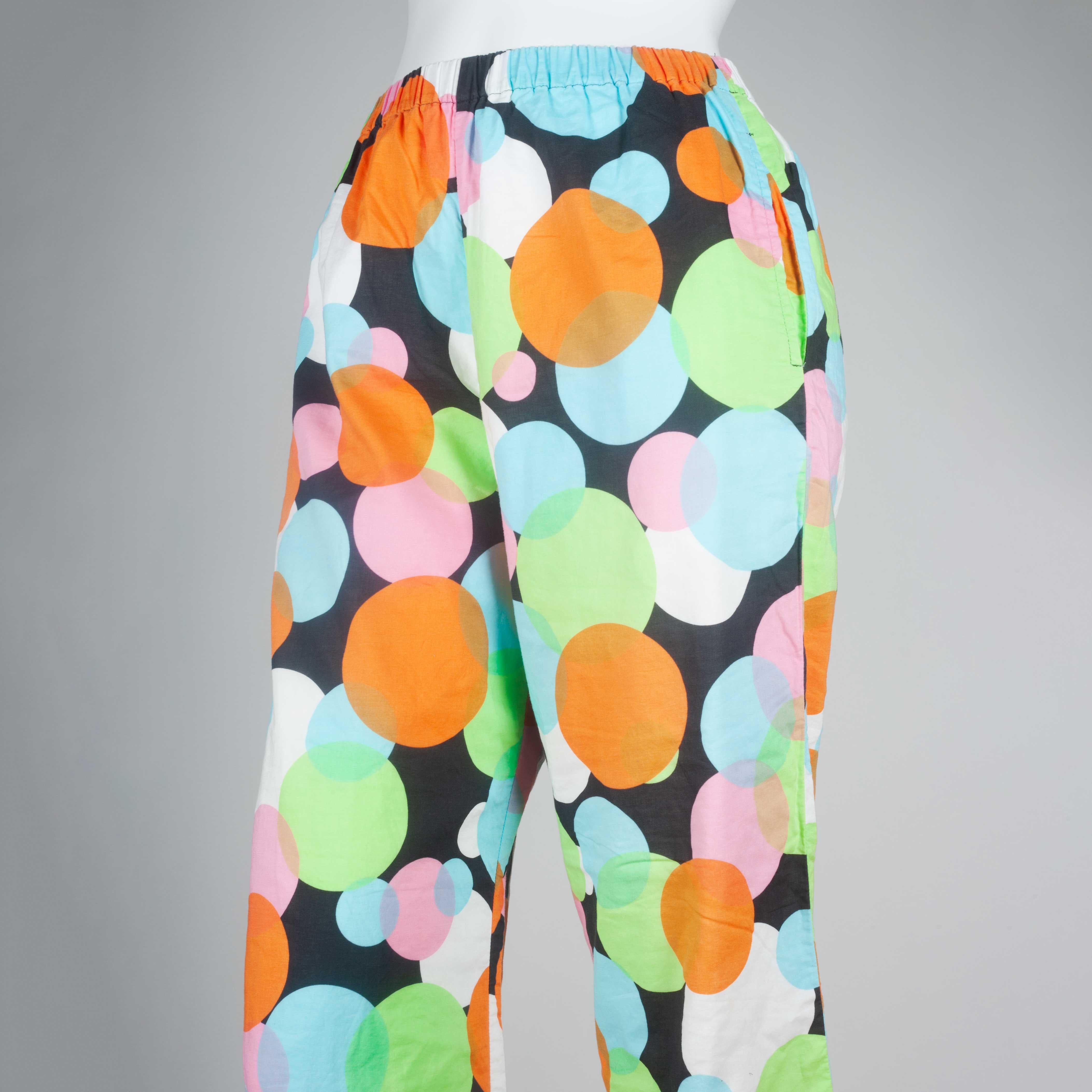 Comme des Garçons 2003 cotton pants from Japan with colorful circles in orange, blue, green, pink and white, all on a black background. Elastic waist. Delicately thin material gives a pleasant, light feel.

YEAR: 2003
MARKED SIZE: No size marked
US