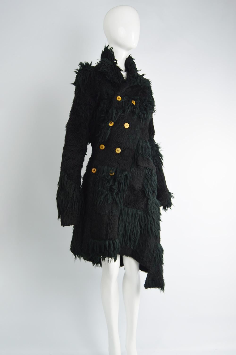 An incredible vintage women's Comme Des Garcons coat from the A/W 2002 collection. The twin of this jacket is in the Met Museums collection. In a patchwork of shaggy black faux fur fabrics with a twisted button fastening that gives a deconstructed
