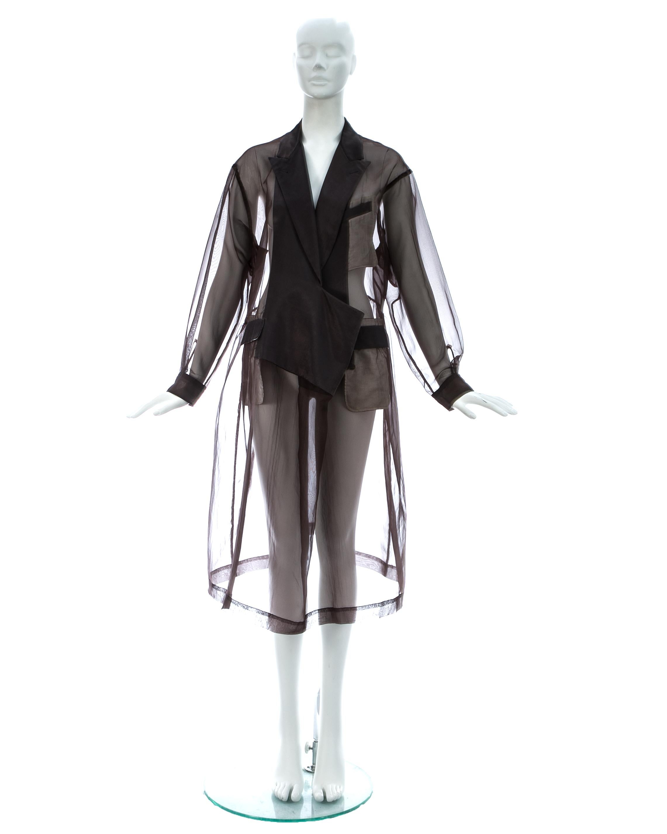 Comme des Garcons; deep mauve organza oversized smock dress with black satin lapels, pockets and cuffs. For the runway presentation these dresses were styled over and under suits.

Spring-Summer 1995