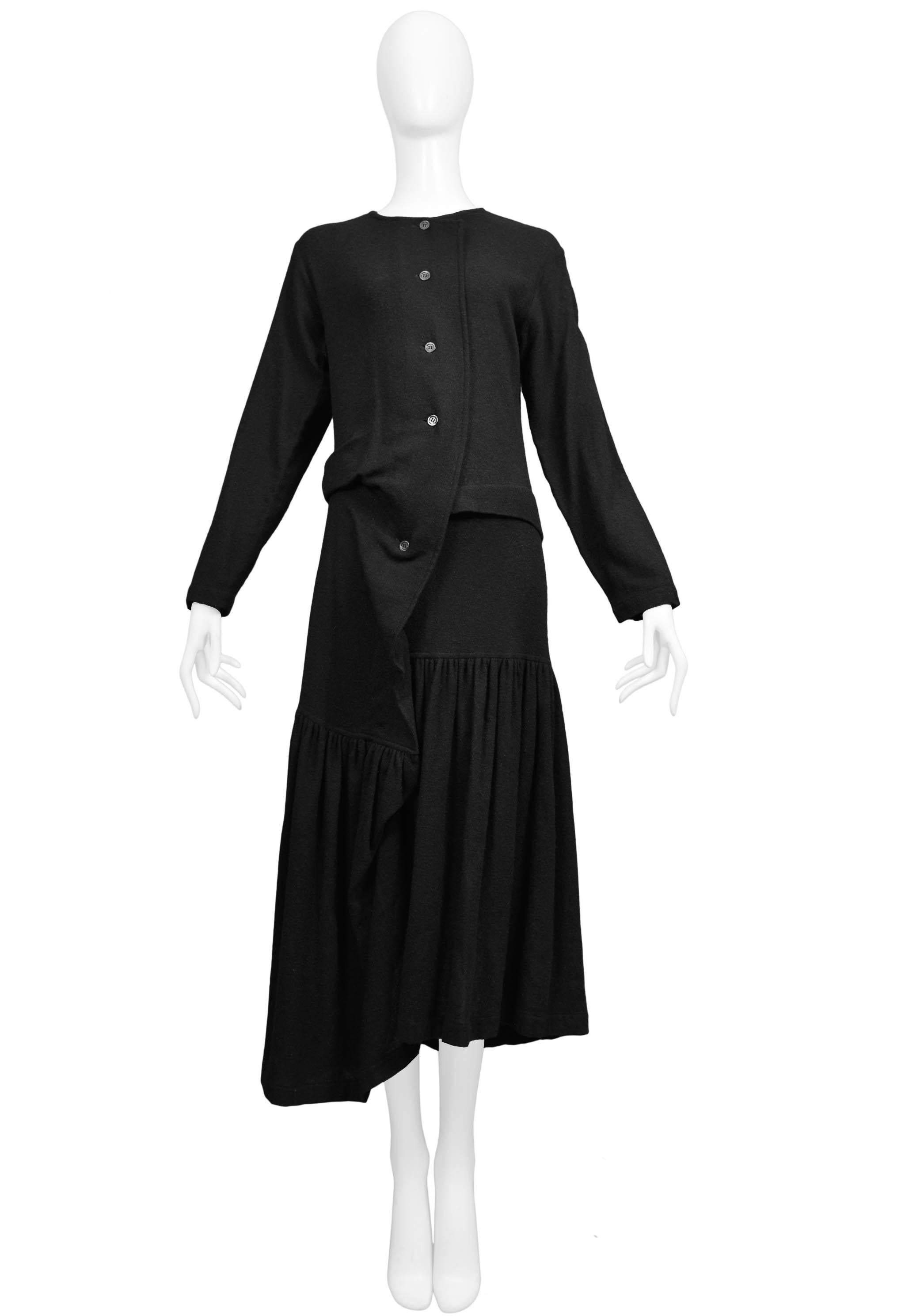 Resurrection Vintage is excited to offer a vintage Comme des Garcons black knit sweater dress featuring an asymmetrical button front, grey buttons, long sleeves, gathered skirt, and an uneven hemline. 

Comme Des Garcons
Size Medium
Wool 
Excellent