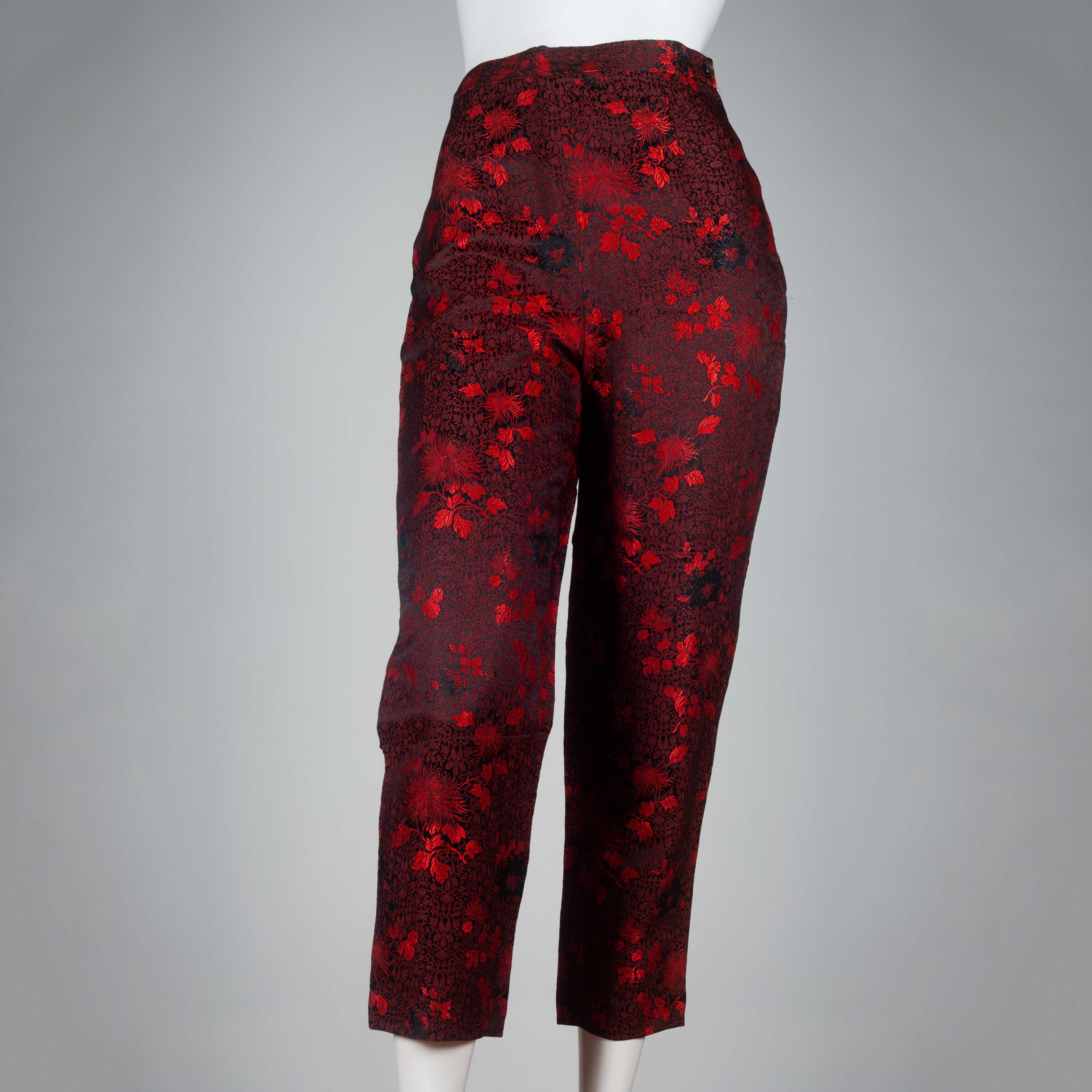 Comme des Garçons 1991 black trousers with bright red all-over flower and leaf embroidery. A rare vintage piece sourced directly from Japan and exhibiting some of the trademarks of the Comme des Garçons brand, notably the use of material and color