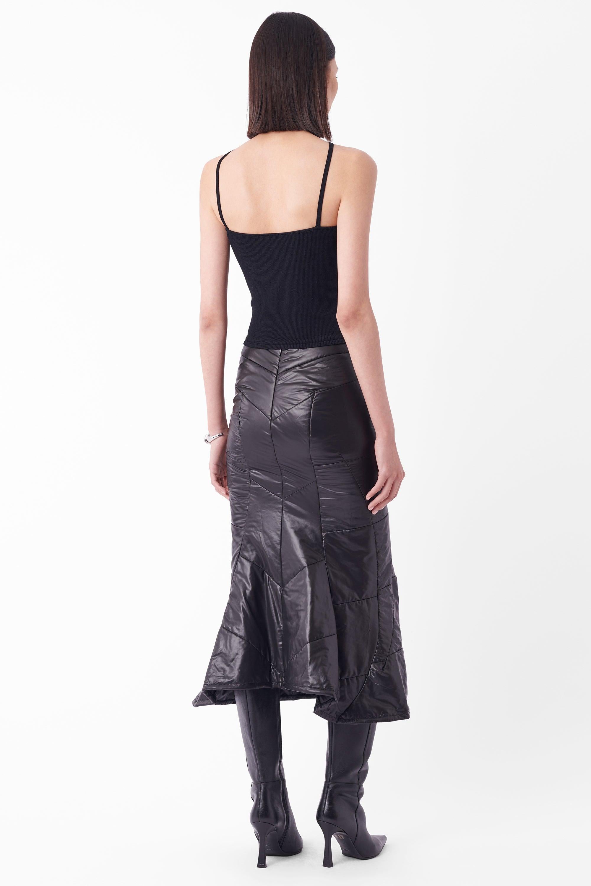 Junya Watanabe Comme Des Garcon Fall Winter 2004 black midi skirt. Features padded puffer detailing all over, fishtail silhouette and zip back closure. In excellent vintage condition.

Styled with our 'Gucci Vintage S/S 2000 Black Vest Top'

Brand: