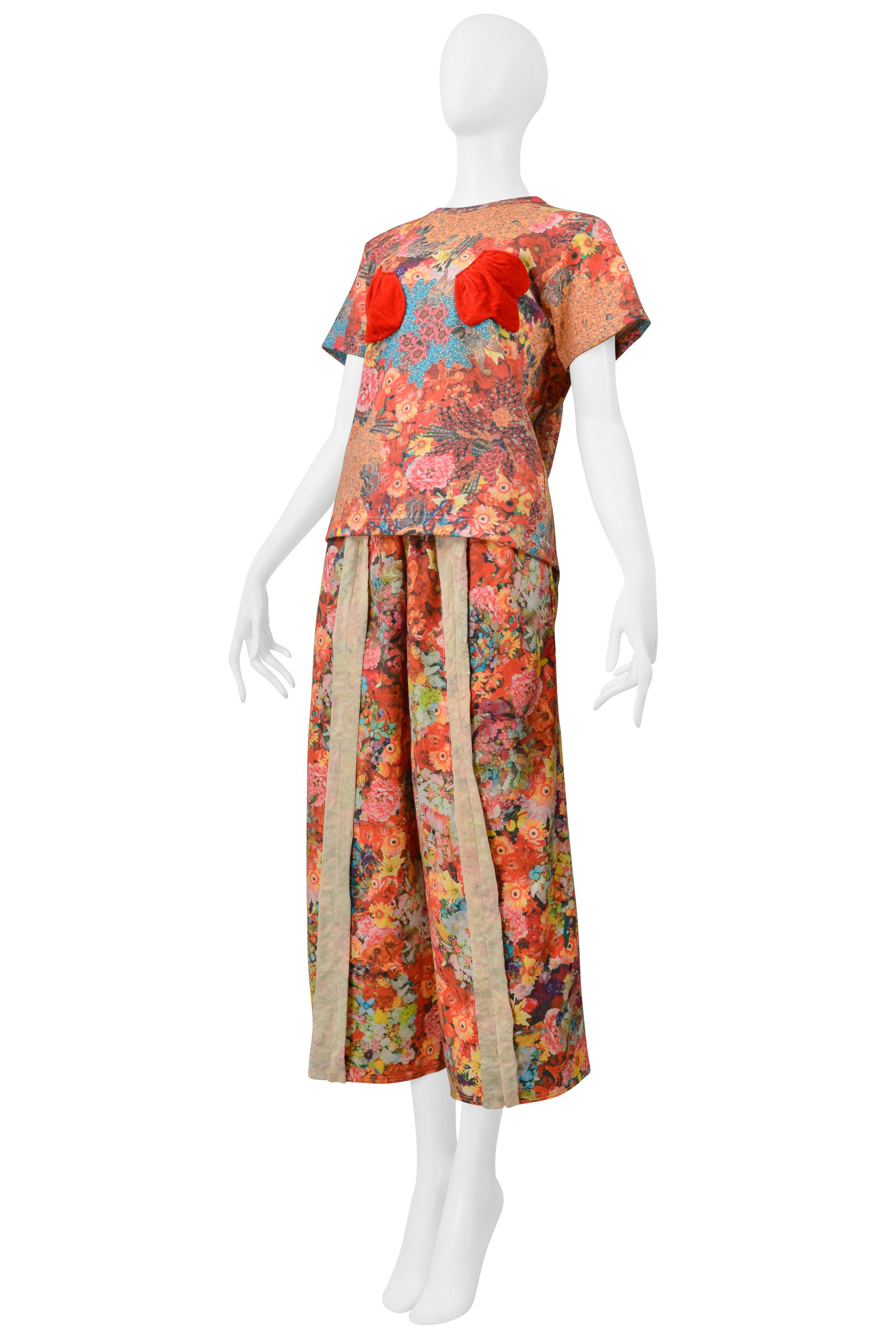 Resurrection Vintage is excited to offer a vintage Comme des Garçons floral pants and t-shirt ensemble from the spring 2004 collection, featuring a short-sleeved t-shirt with red 3d appliques, canvas panels down the center of the pants, and a