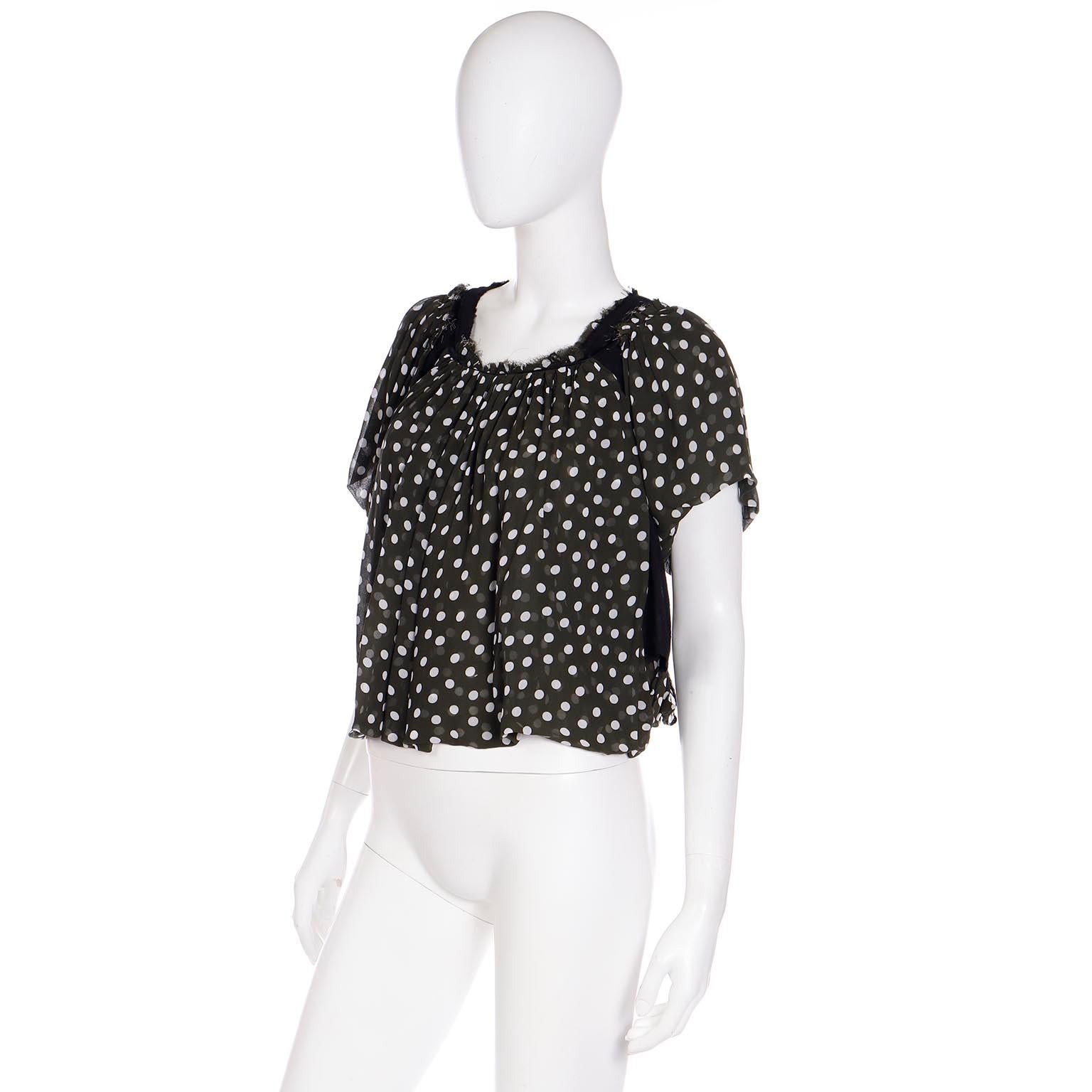 This is a fun Comme des Garcons deconstructed olive green polka dot cropped top, with pretty gathering at the neckline. We love Comme des garcons and this top has so much style and so many unique elements! Around the neckline there is also a black