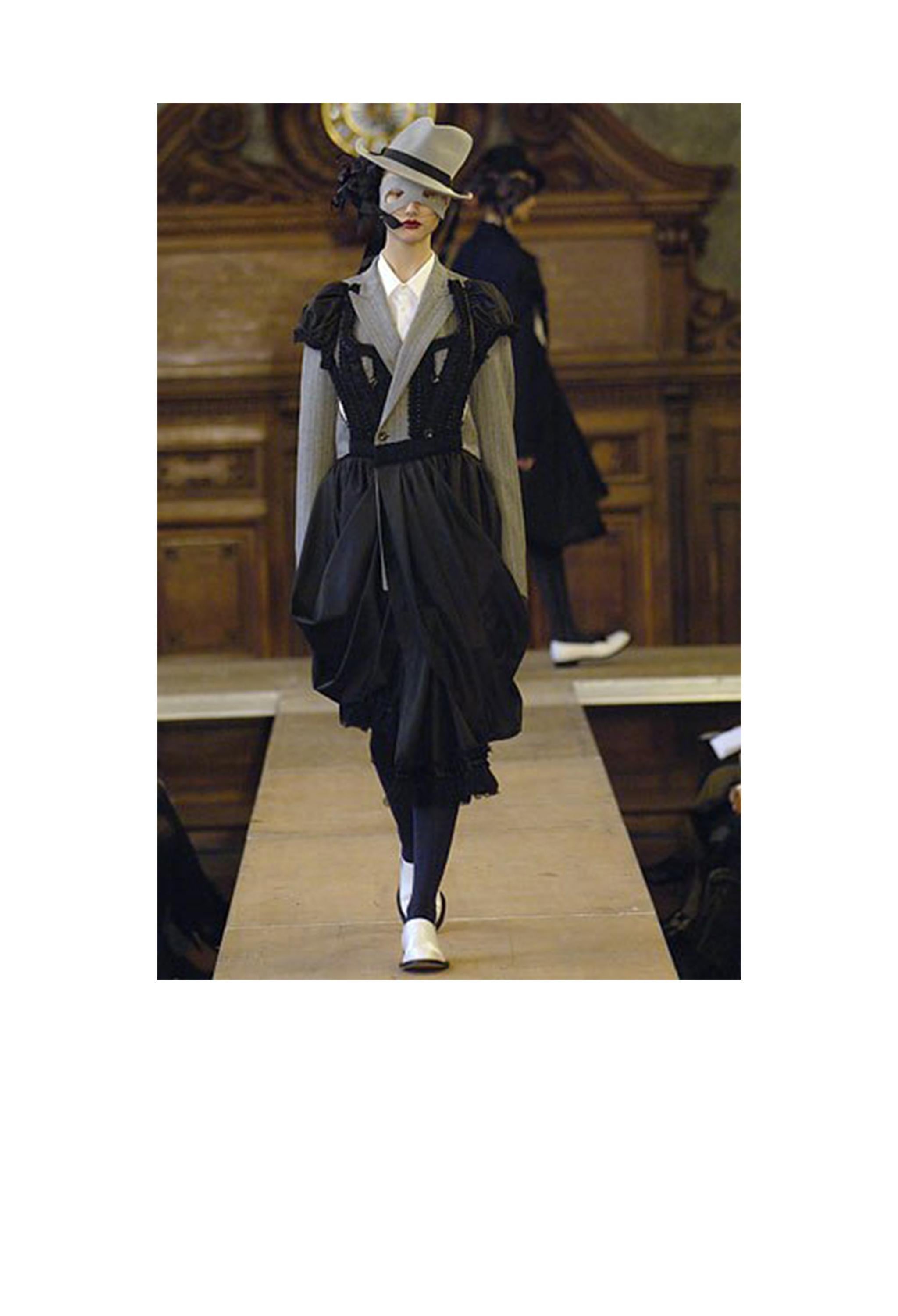 Resurrection Vintage is excited to offer a vintage Comme des Garcons a black fancy dress attached to a double-breasted grey jacket with an attached skirt in the front. From the AW 2006 collection.

Comme Des Garcons
Size: Small
Measurements: Bust