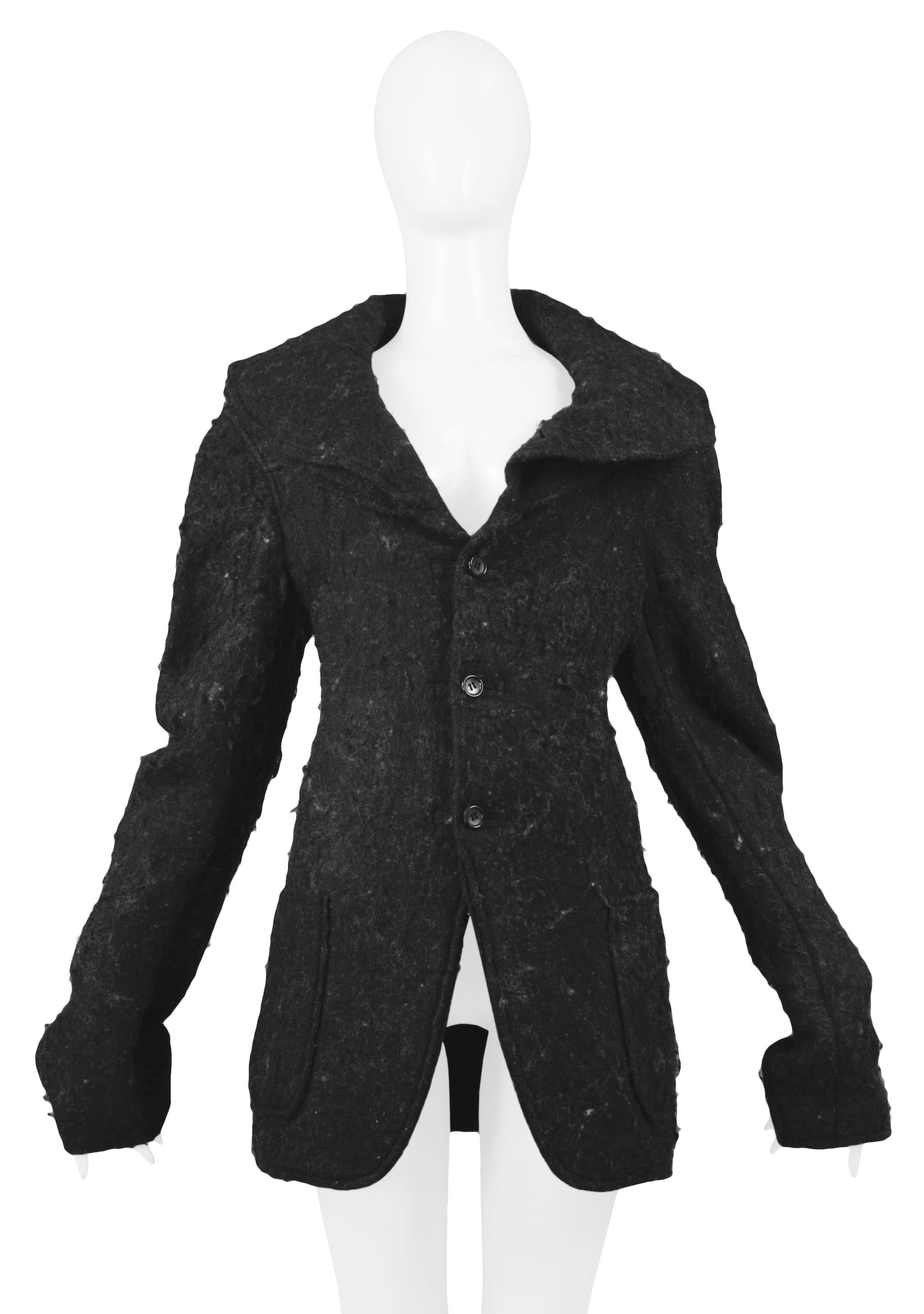 Resurrection is pleased to offer this vintage Comme des Garcons charcoal grey boiled wool three-button jacket with oversized double-layer collar, extra long sleeves, and pockets at hips.

Comme Des Garcons
Size: Medium 
Fabric: Wool 
Excellent