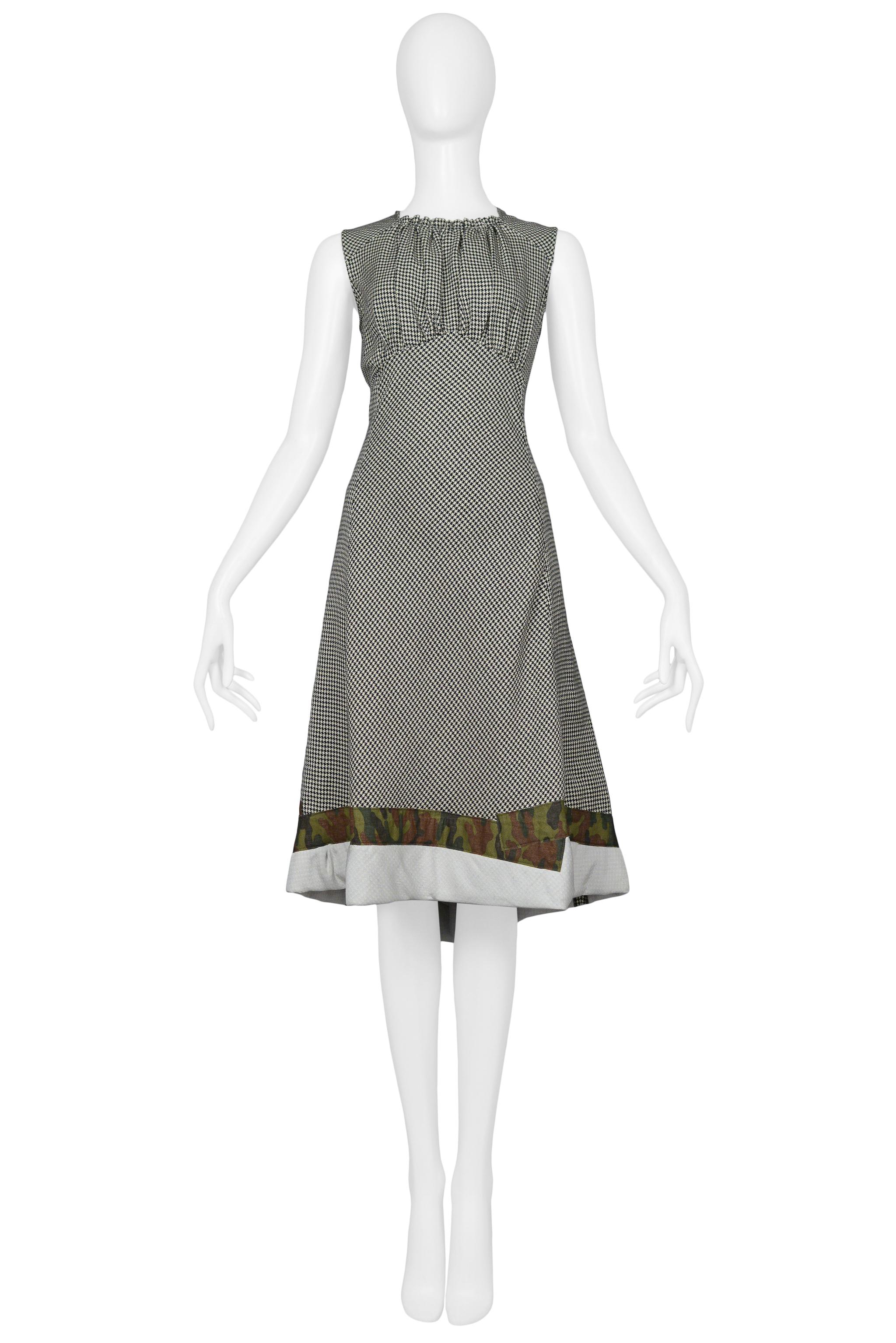 Resurrection Vintage is excited to offer a vintage Comme des Garcons black and white herringbone dress with camouflage trim at the hem, gathered bodice, and empire bustline. From the SS 2001 collection.

Comme Des Garcons
Size: Small
Measurements: