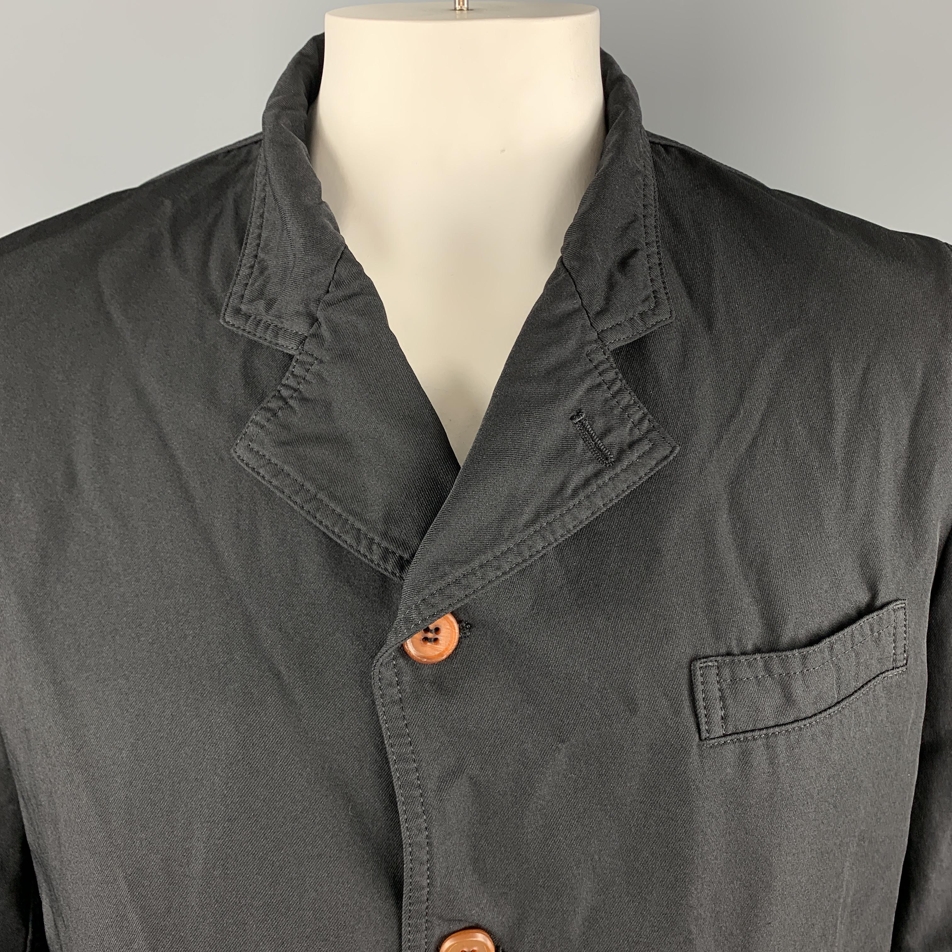 COMME des GARCONS HOMME DEUX sport coat comes in wrinkle textured black poly twill with a notch lapel, single breasted, four button front, and functional button cuffs. Made in Japan.

Excellent Pre-Owned Condition.
Marked: XL AD