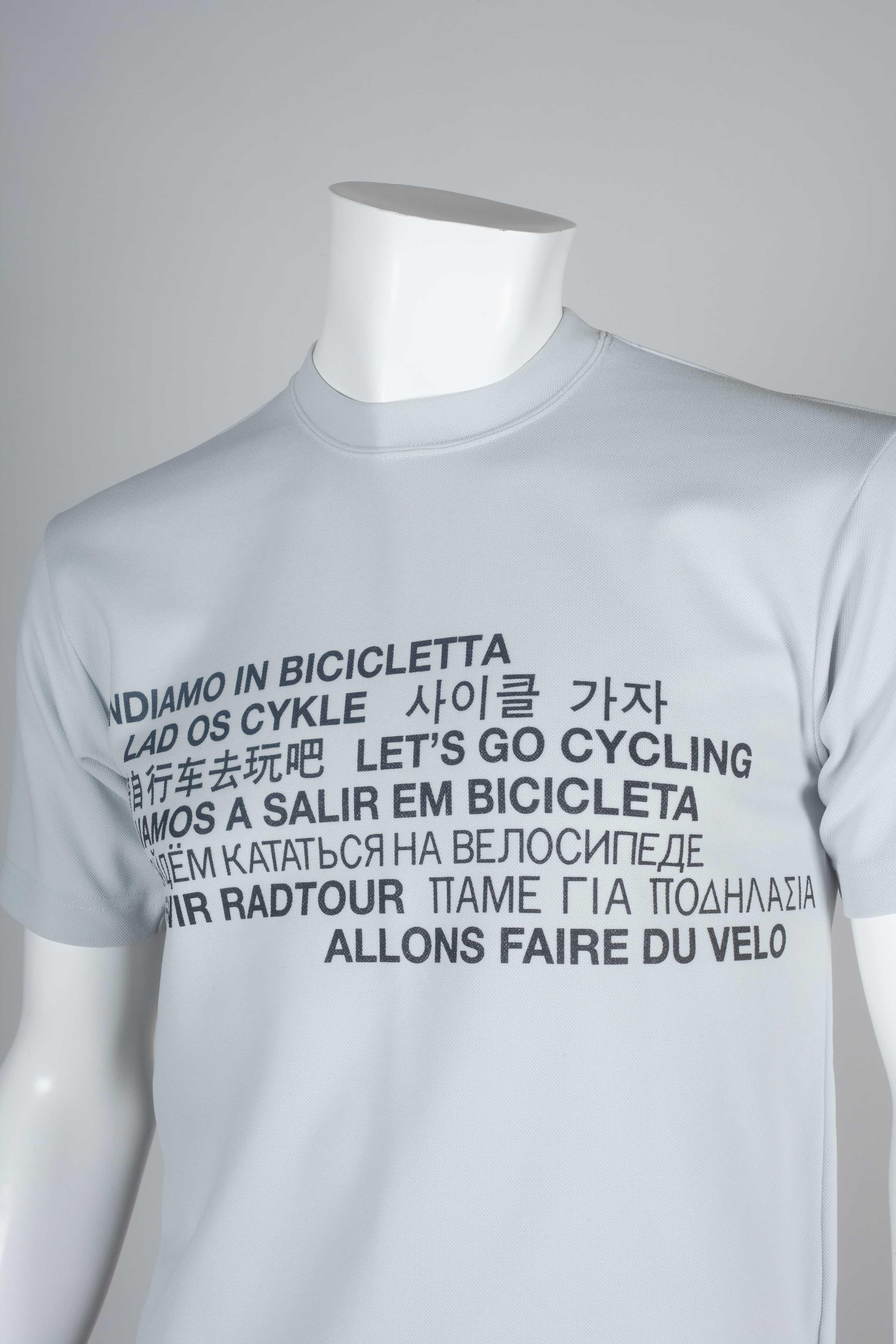 Comme des Garçons Homme 2001 gray cycling t-shirt with the sentence, 