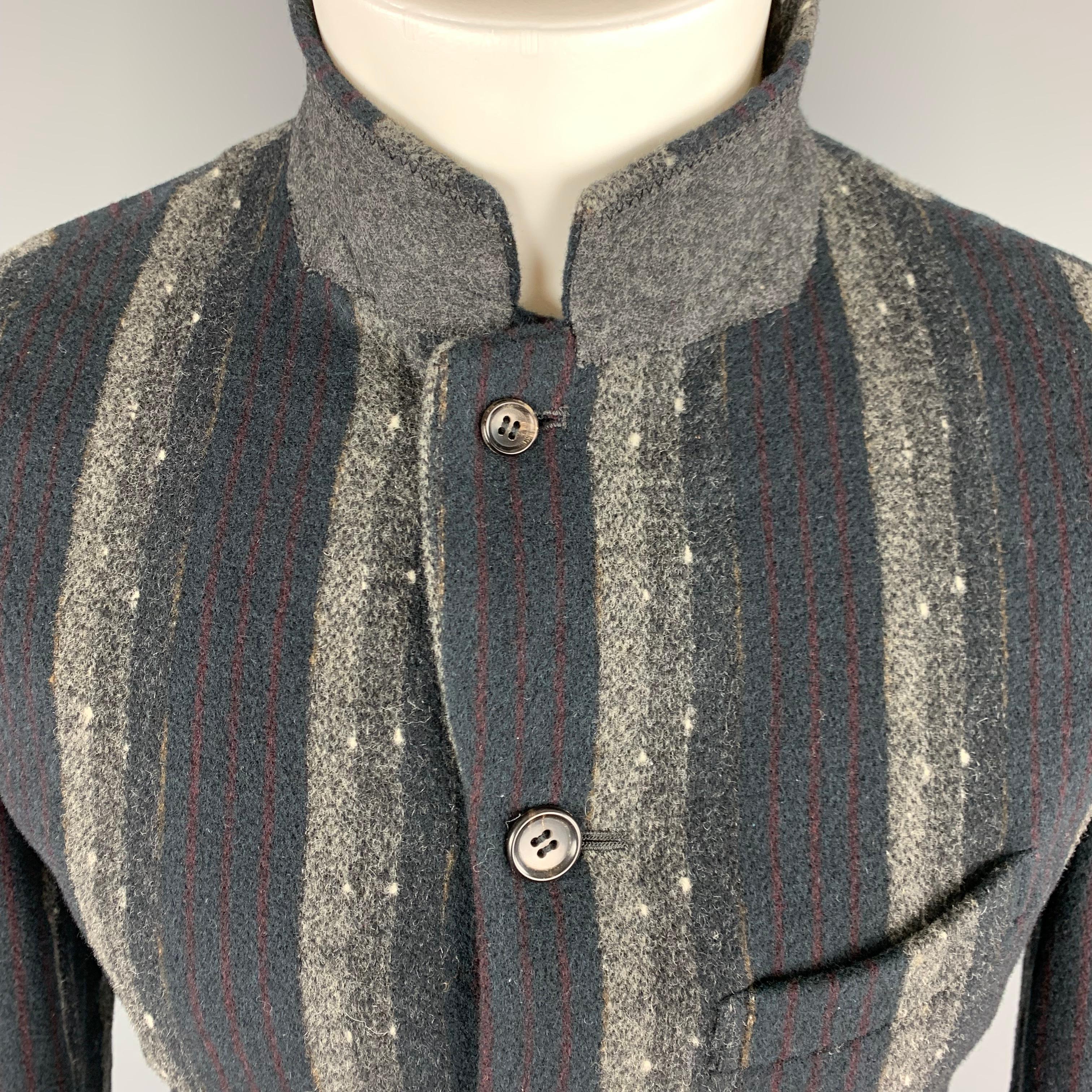 COMME DES GARCONS HOMME PLUS Sport Coat comes in navy and grey tones in a striped wool blend material, with a notch lapel, slit and flap pockets, 4-5  buttons at closure, belt at back, single breasted and buttoned cuffs. AD2000. Made in Japan
