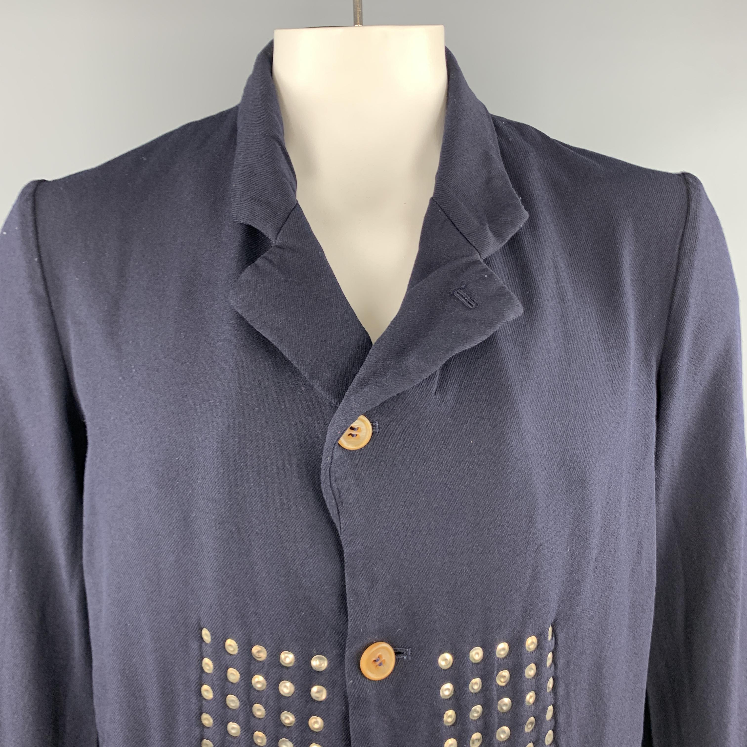 COMME des GARCONS HOMME PLUS EVER GREEN sport coat comes in navy twill with a pointed lapel, four button single breasted, front, and reverse stud embellishments. Looks great inside out.  Made in Japan.

Excellent Pre-Owned Condition.
Marked: