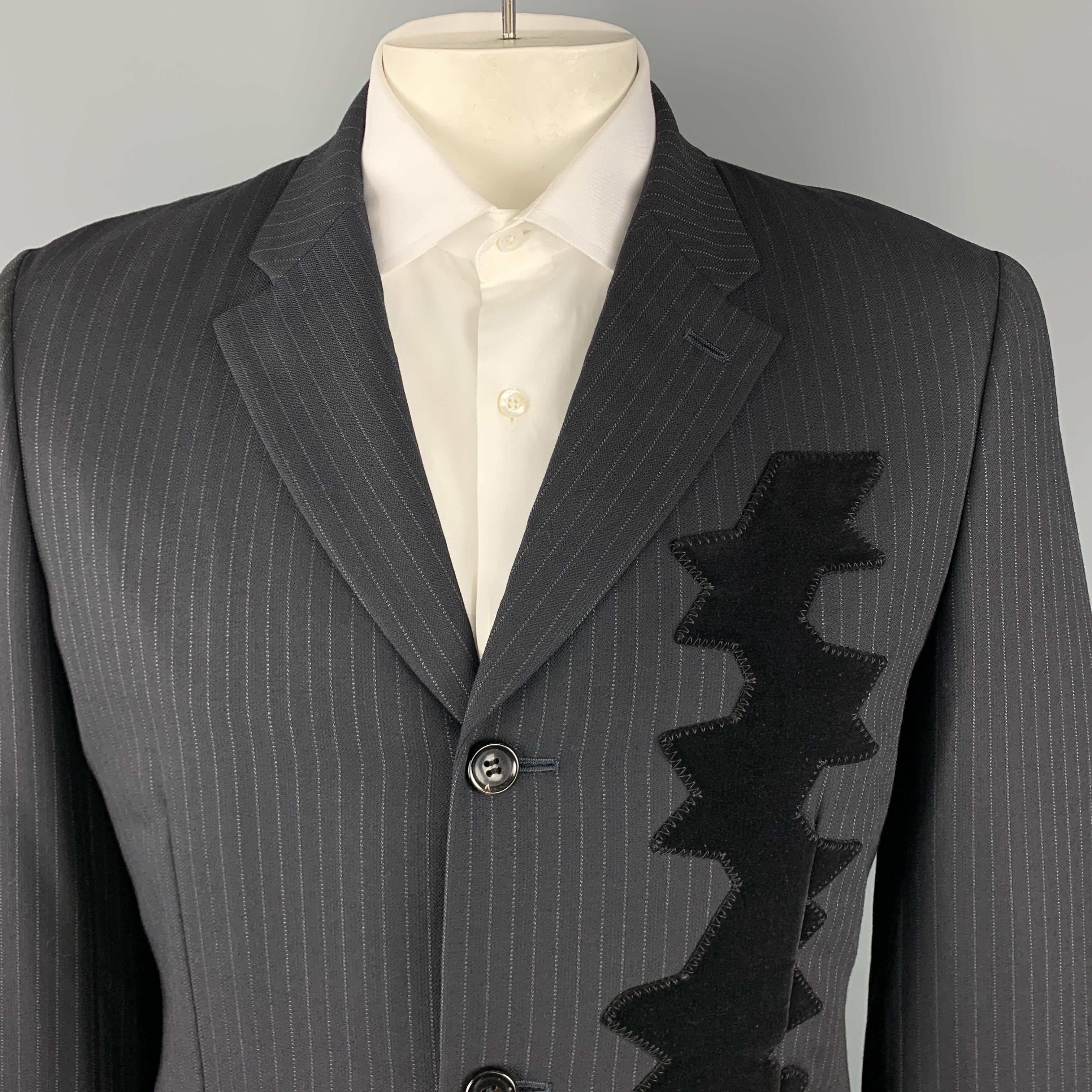 COMME des GARCONS HOMME PLUS sport coat comes in black pinstriped wool with a notch lapel, single breasted, three button front, and velvet applique patch. Made in Japan.

Excellent Pre-Owned Condition.
Marked: L AD 2006

Measurements:

Shoulder: 18