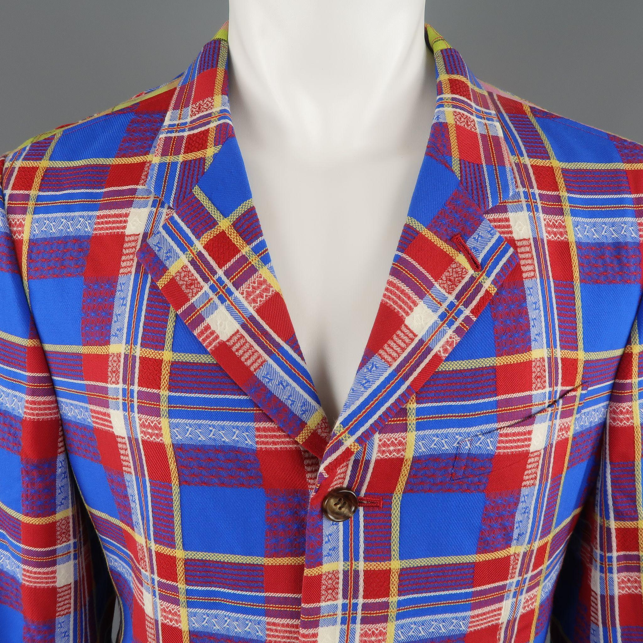 This rare vintage COMME des GARCONS HOMME PLUS circa 2001 Docking sport jacket comes in a bold blue red and yellow plaid textured wool with a notch lapel, single breasted three button front, and pink and green plaid panels throughout. Tailors faint
