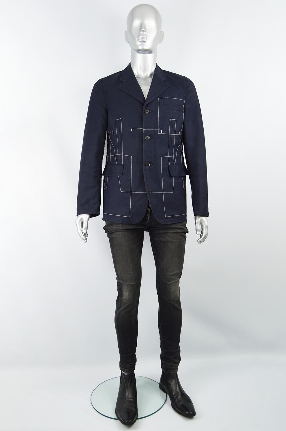 An excellent vintage men's jacket by iconic Japanese fashion label, Comme Des Garcons for their mens Homme Plus line. In a dark blue cotton blend with amazing white top stitching that gives an architectural / sculptural feel. This tailored jacket