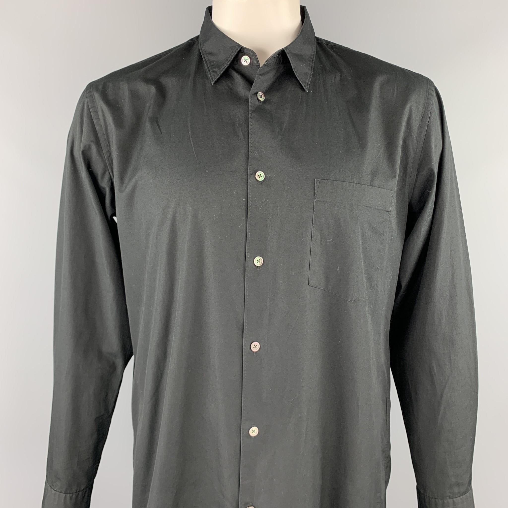 COMME des GARCONS HOMME PLUS long sleeve shirt comes in a black cotton featuring a long button up style, front patch pocket. Made in Japan.

Excellent Pre-Owned Condition.
Marked: L

Measurements:

Shoulder: 18.5 in. 
Chest: 44 in. 
Sleeve: 25.5 in.