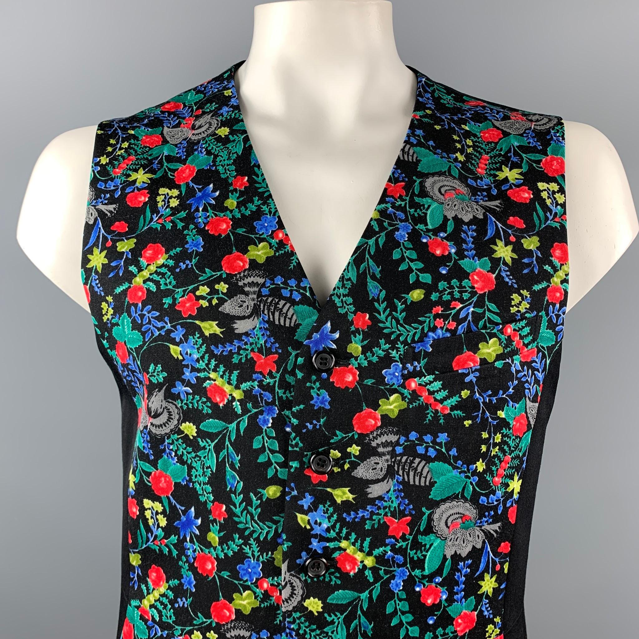 COMME des GARCONS HOMME PLUS vest comes in a multi-color floral print wool with a full liner featuring a mini slit pocket and a buttoned closure. Made in Japan.

Excellent Pre-Owned Condition.
Marked: L

Measurements:

Shoulder: 16 in. 
Chest: 40