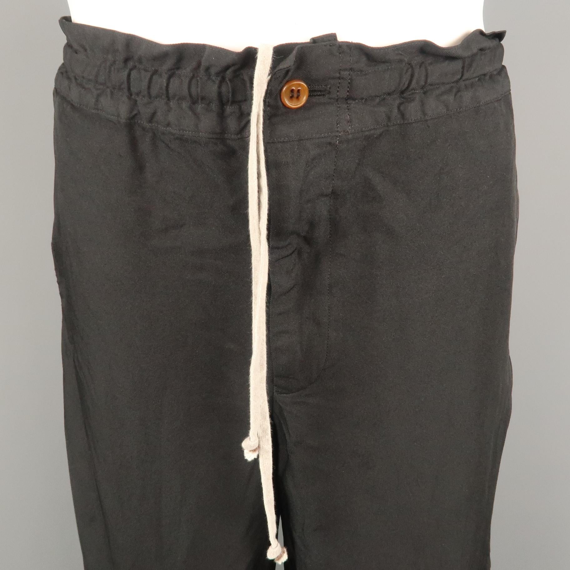 COMME des GARCONS HOMME PLUS casual pant comes in a black polyester featuring a regular fit and drawstring style. Made in Japan.
 
Very Good Pre-Owned Condition.
Marked: L
 
Measurements:
 
Waist: 34 in.
Rise: 10 in.
Inseam: 29 in.
