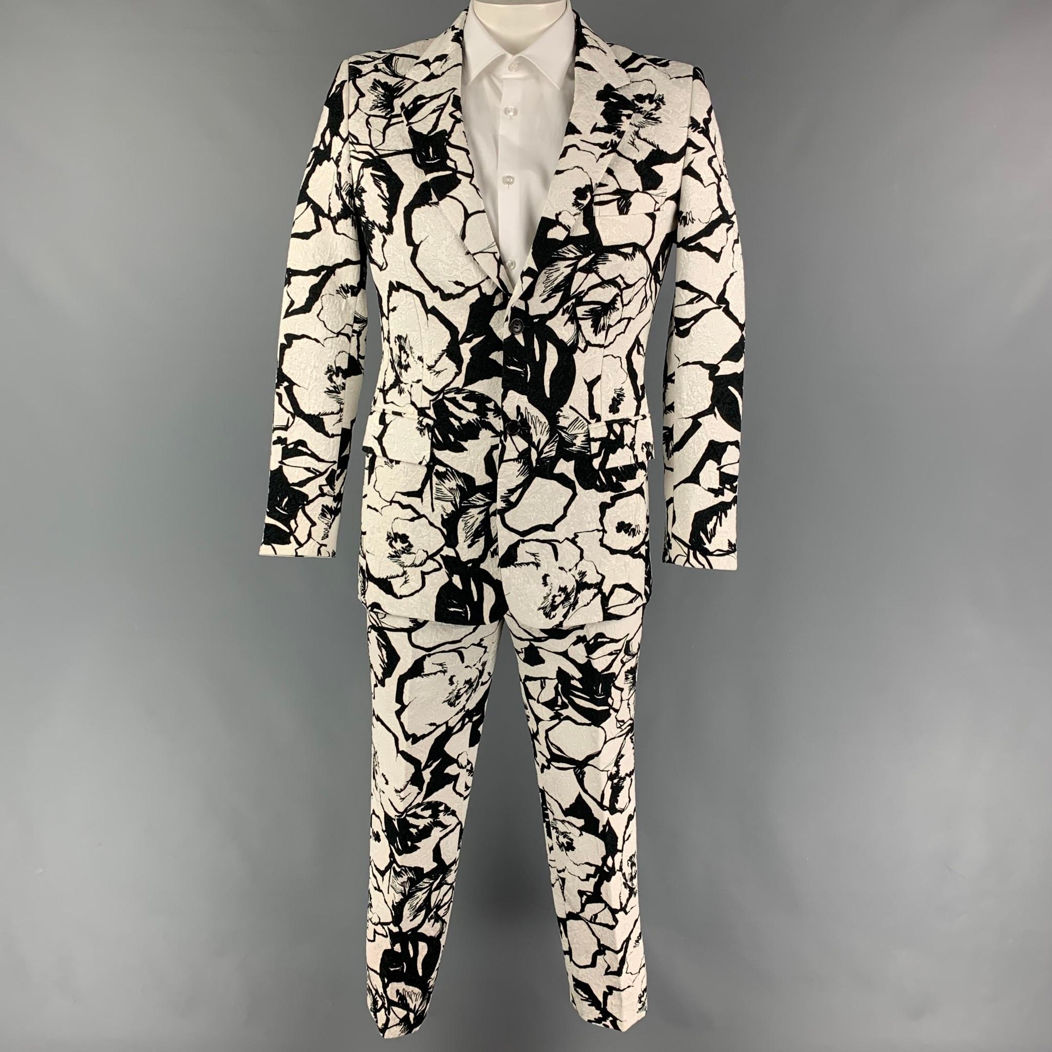 COMME des GARCONS HOMME PLUS suit comes in a black & white jacquard cotton with a half liner and includes a single breasted, double button sport coat with a notch lapel and matching flat front trousers. Made in Japan.

Very Good Pre-Owned
