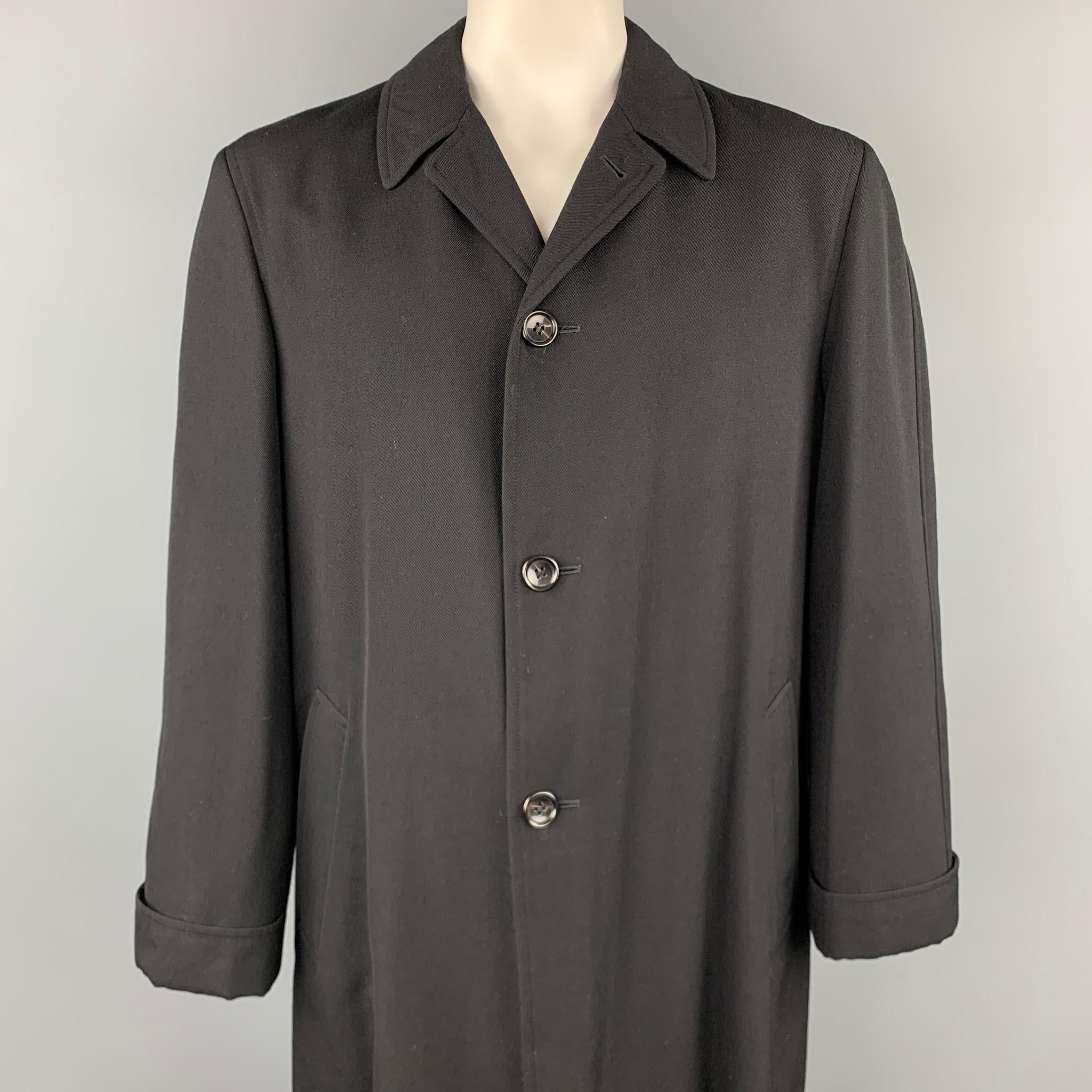 COMME des GARCONS HOMME PLUS coat comes in a black wool with a half liner featuring a half cuffed sleeve, slit pockets, spread collar, and a buttoned closure. Made in Japan.

Excellent Pre-Owned Condition.
Marked: L

Measurements:

Shoulder: 18.5