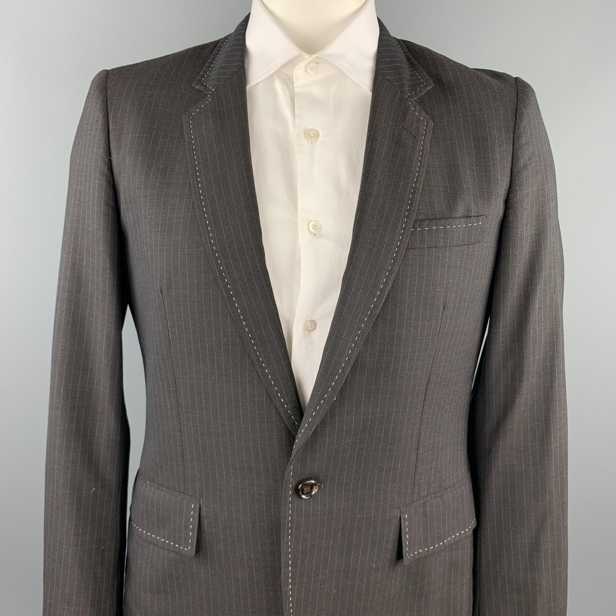 COMME des GARCONS HOMME PLUS sport coat comes in a charcoal vertical stripe wool / polyester with a half liner featuring notch lapel, flap pockets, and a single button closure. Made in Japan.

Excellent Pre-Owned Condition.
Marked: L / AD