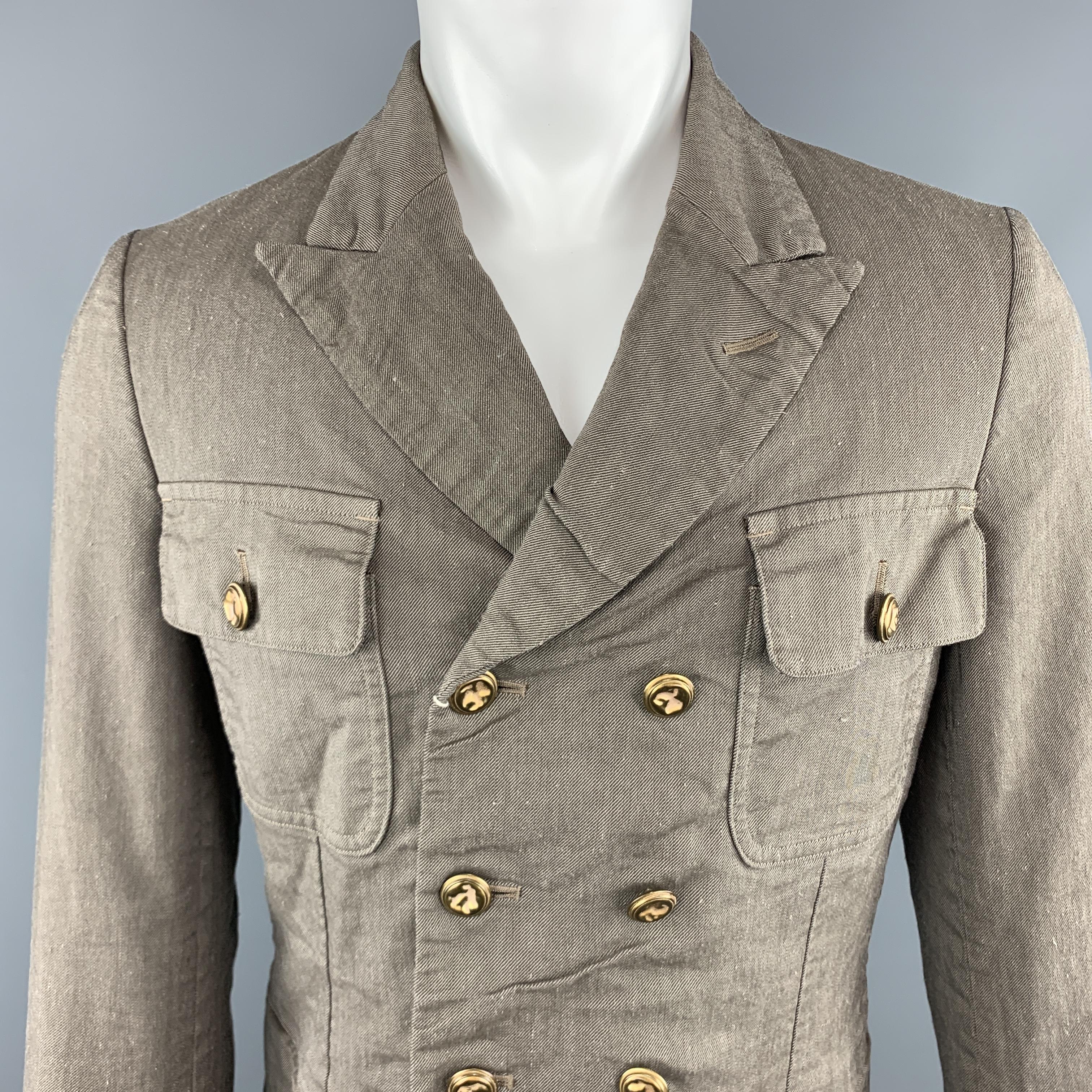 COMME des GARCONS HOMME PLUS military style jacket comes in a distressed textured linen blend twill with gold tone hammered buttons, double breasted front, patch flap pockets, peak lapel, flap button cuffs. Made in Japan.

New with Tags. Pre-Owned
