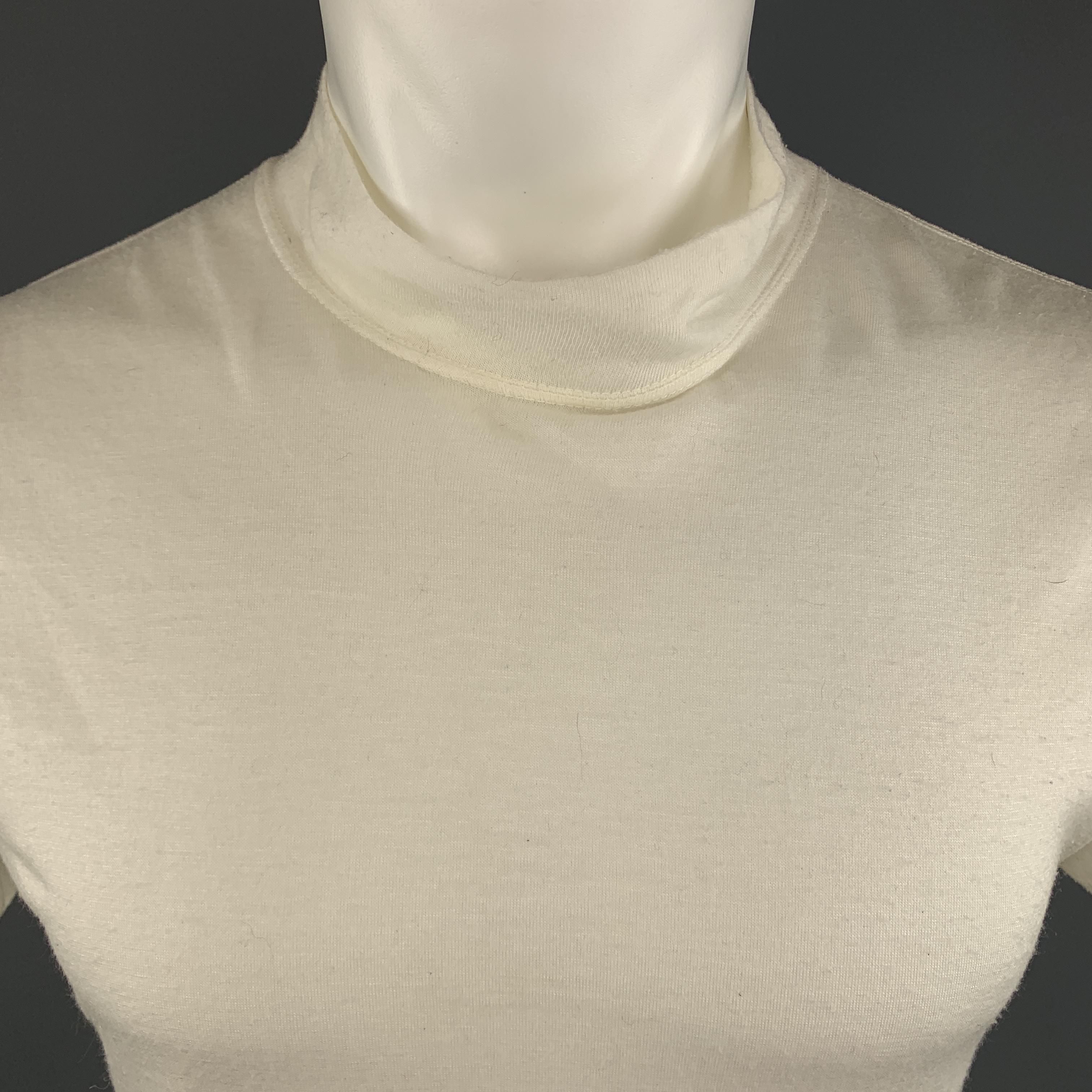 COMME DES GARCONS HOMME PLUS T-shirt comes in a white tone in a solid acrylic material, with a mock neck, short sleeves and a color trim at hem. AD1996. Made in Japan.
 
Very Good  Pre-Owned Condition.
Marked: No Size
 
Measurements:
 
Shoulder: 17