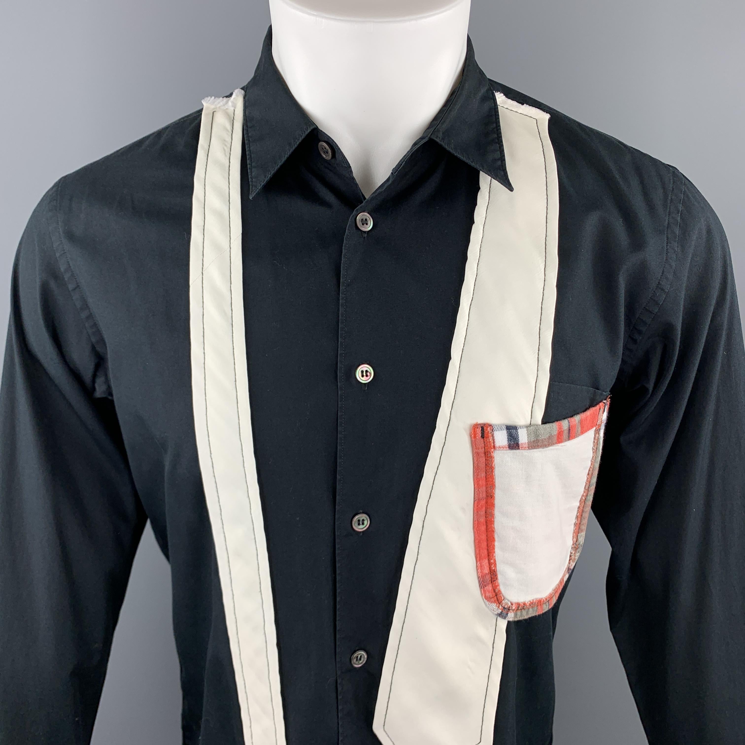 COMME des GARCONS HOMME PLUS long sleeve shirt comes in a solid black cotton material, with a white deconstructed tie applique, a patchwork patch pocket, and buttoned cuffs. Made in Japan.

Very Good Pre-Owned Condition.
Marked: S 
