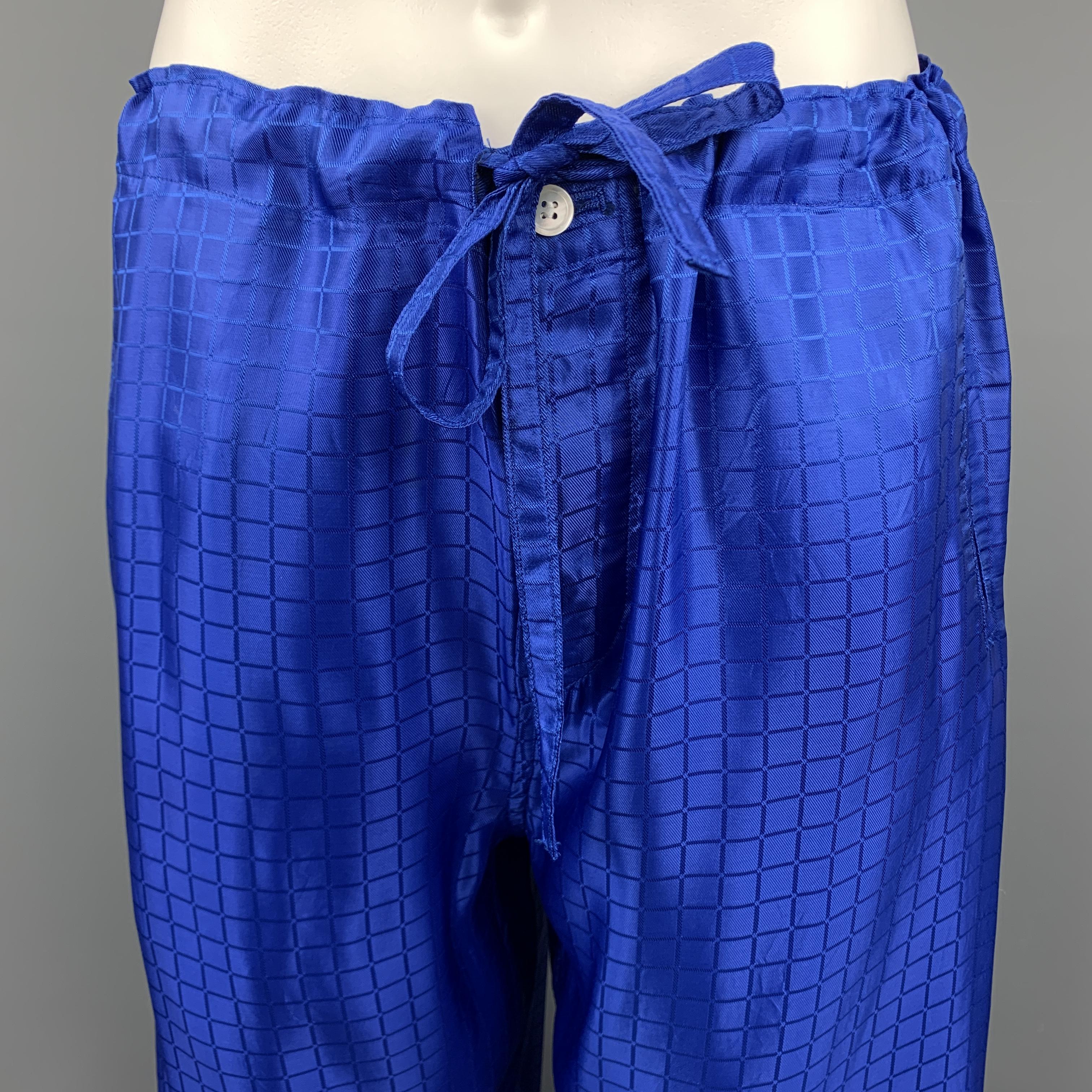 COMME des GARCONS HOMME PLUS Casual pants comes in a window pane blue C pattern acetate / rayon material, featuring a drawstring, slit pockets, wide legs, button fly. Made in Japan.

Excellent Pre-Owned Condition.
Marked: S

Measurements:

Waist: 42