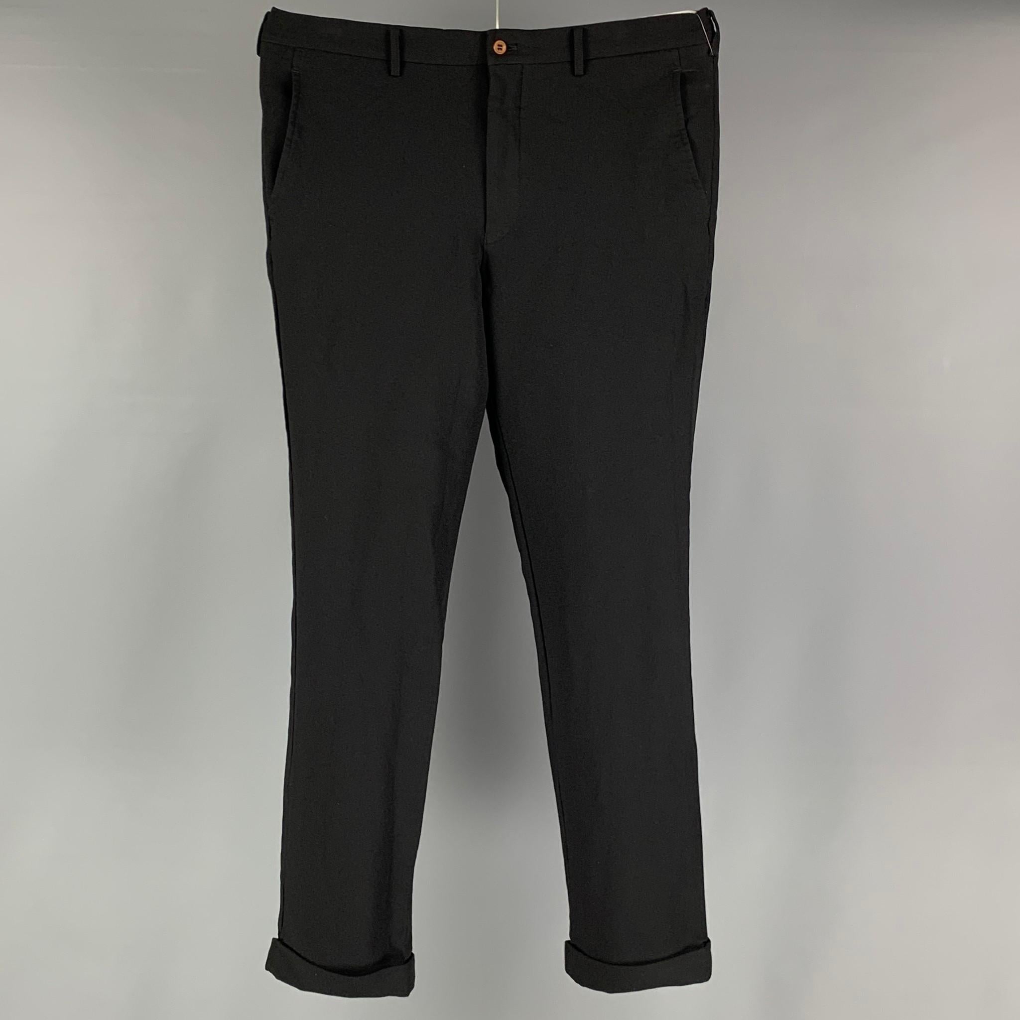 COMME des GARCONS HOMME PLUS dress pants comes in a black polyester twill material featuring a flat front, front & back pockets, and a zip fly closure. Made in Japan.

Very Good Pre-Owned Condition.
Marked: XL / AD2015

Measurements:

Waist: 36