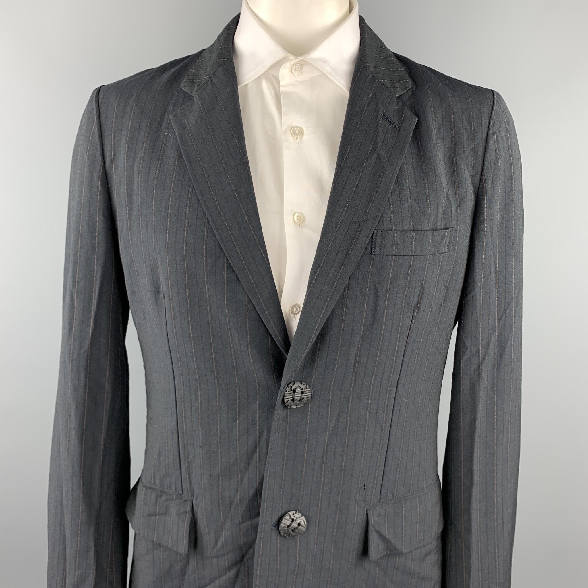COMME des GARCONS HOMME PLUS sport coat comes in a slate vertical stripe wool blend with a half liner featuring a notch lapel, flap pockets, and a two button closure. Made in Japan.

Good Pre-Owned Condition.
Marked: XL / AD