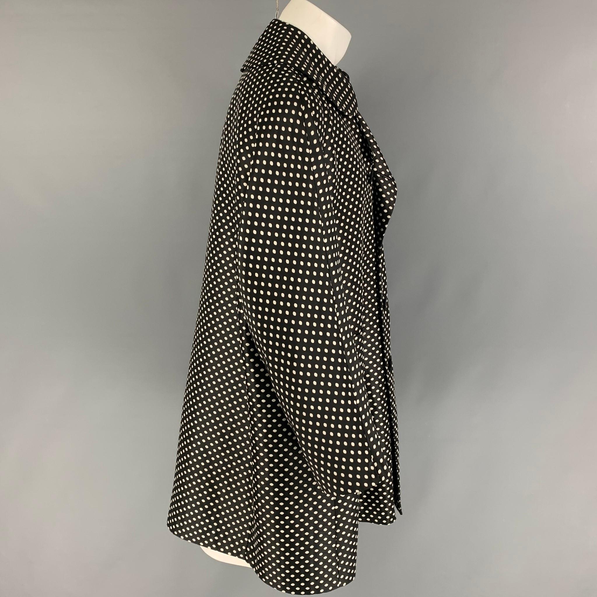 COMME des GARCONS HOMME PLUS coat comes in a black & white polka dot polyester featuring a oversized fit, patch pockets, and a double breasted closure. Made in Japan. 

Very Good Pre-Owned Condition. Light discoloration at lapel.
Marked: