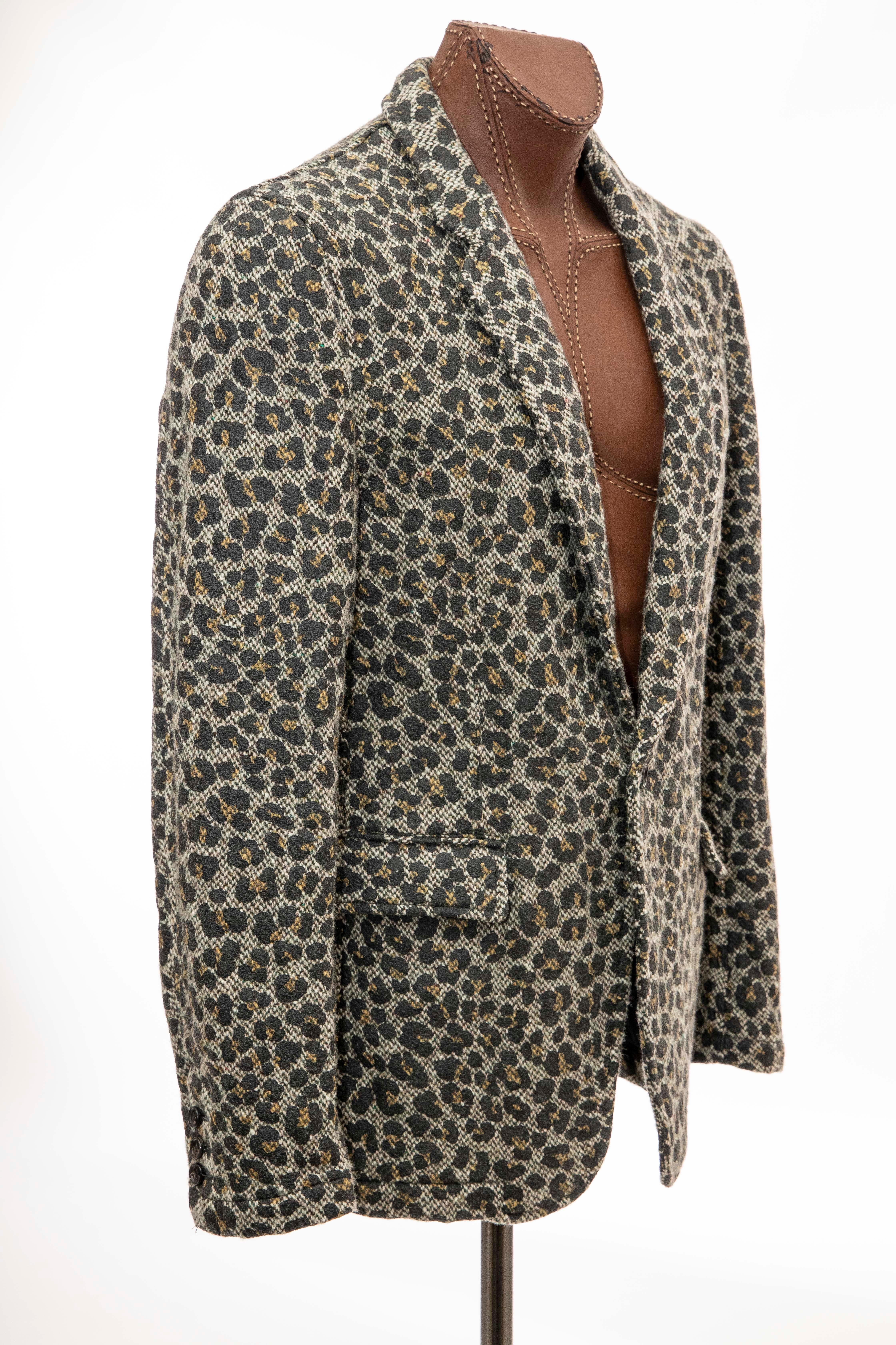 Comme des Garçons Homme Plus, Fall 2009 wool tweed leopard print  blazer with notched lapels, leopard print throughout, three exterior pockets, single vent, long sleeves, black cotton woven lining and one-button closure.

Japan: Large

Chest: 43.5,