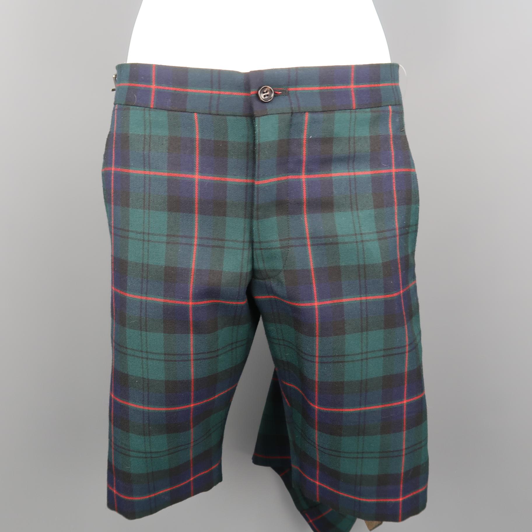 COMME des GARCONS HOMME PLUS shorts come in green, navy, and red tartan plaid wool blend twill with a flat front, half pleated kilt overlay fastened by a black leather side belt tab. Made in Japan.
 
Excellent Pre-Owned Condition.
Marked: XS