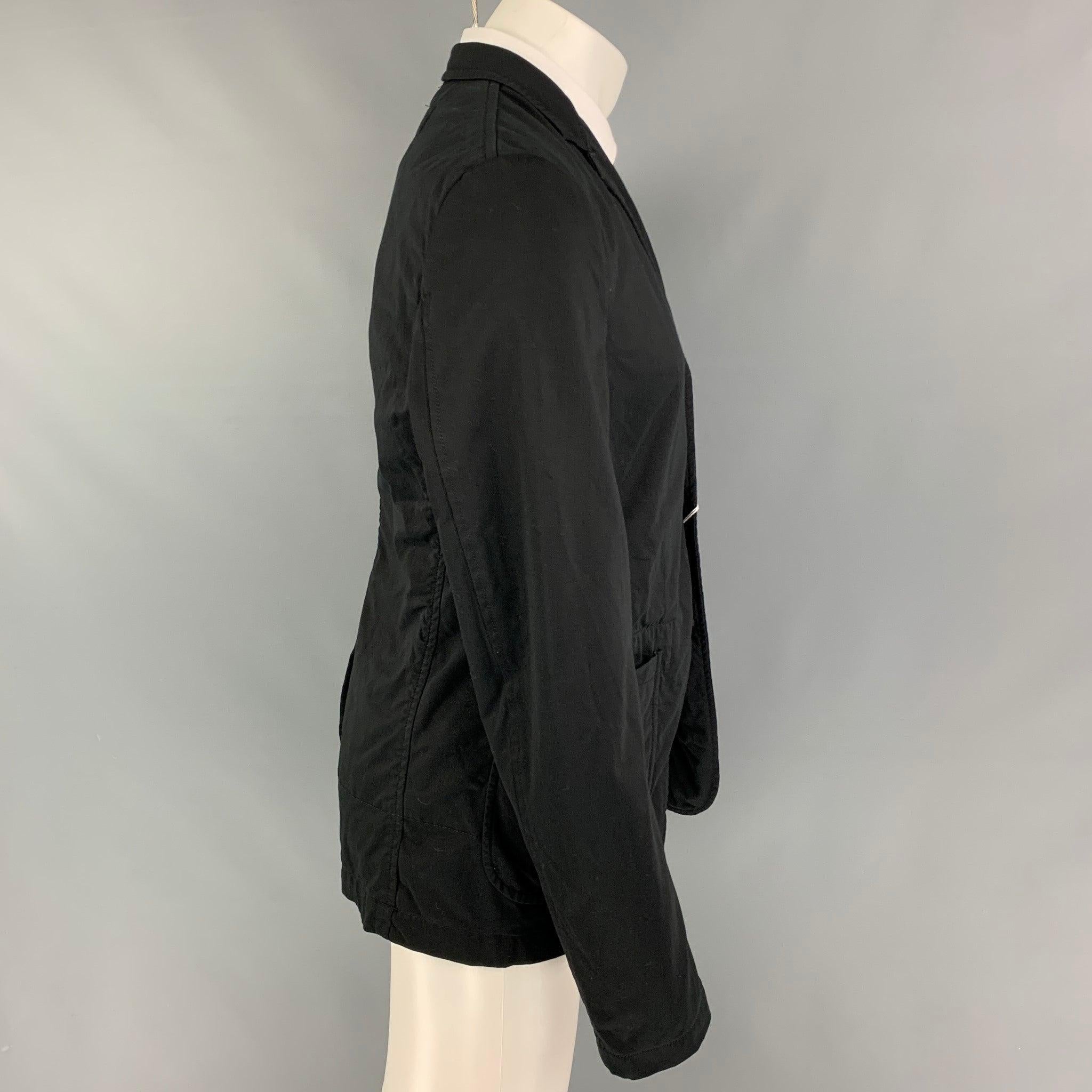 COMME des GARCONS HOMME PLUS sport coat comes in a black cotton blend with a full stripe liner featuring a notch lapel, patch pockets, single back vent, and a three button closure. Made in Japan.
New With Tags.
 

Marked:   L / AD2015