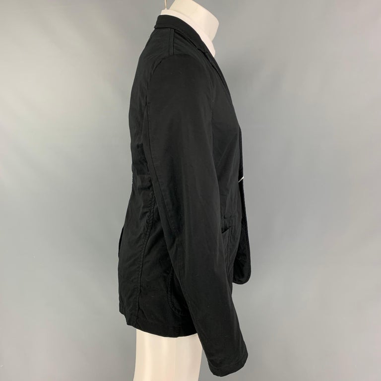 COMME des GARCONS HOMME PLUS sport coat comes in a black cotton blend with a full stripe liner featuring a notch lapel, patch pockets, single back vent, and a three button closure. Made in Japan. 

New With Tags. 
Marked: L /