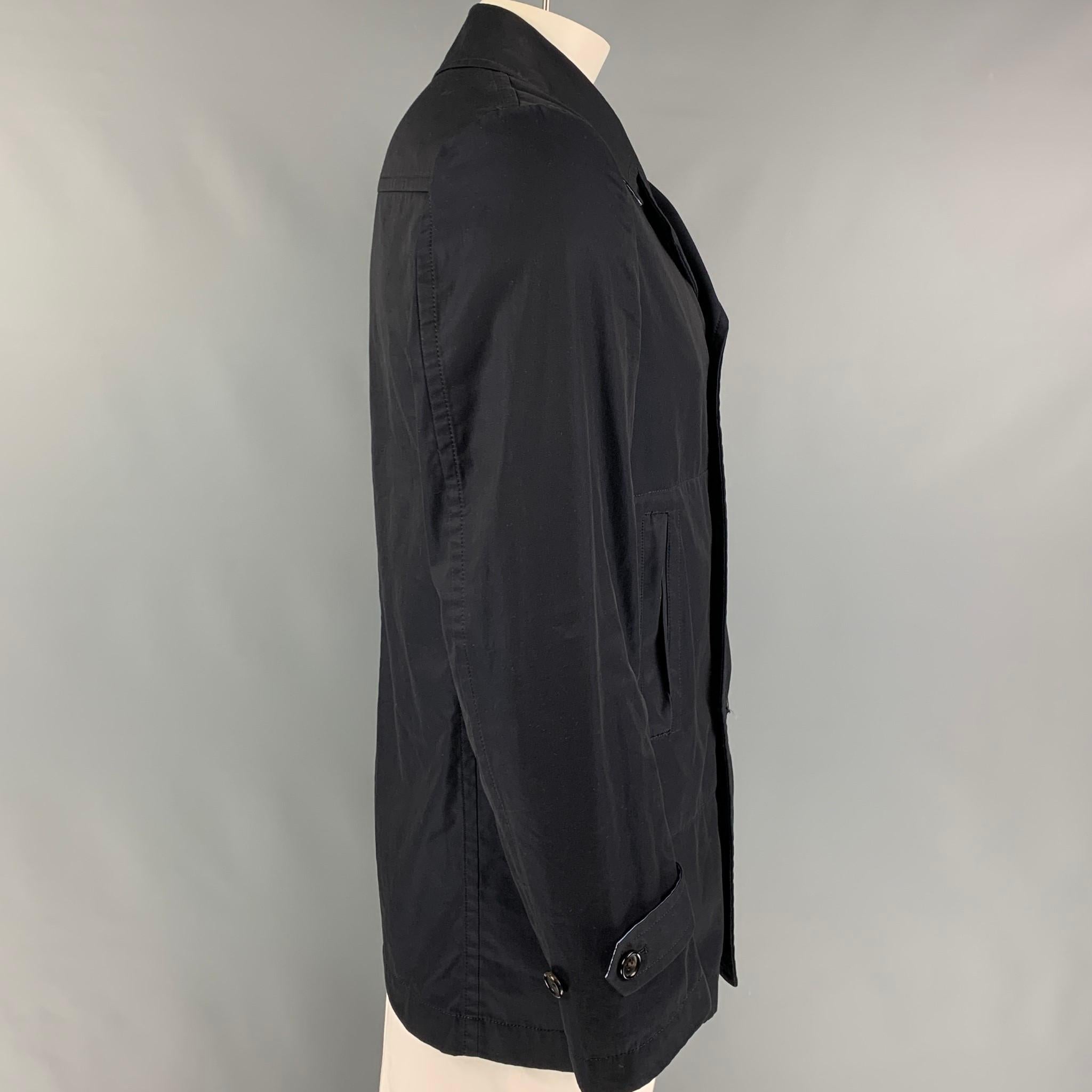 COMME des GARCONS HOMME coat comes in a navy cotton with a stipe trim lining featuring a notch lapel, slit pockets, and a double breasted closure. Made in Japan. 

Very Good Pre-Owned Condition.
Marked: AD2008 / L

Measurements:

Shoulder: 17.5