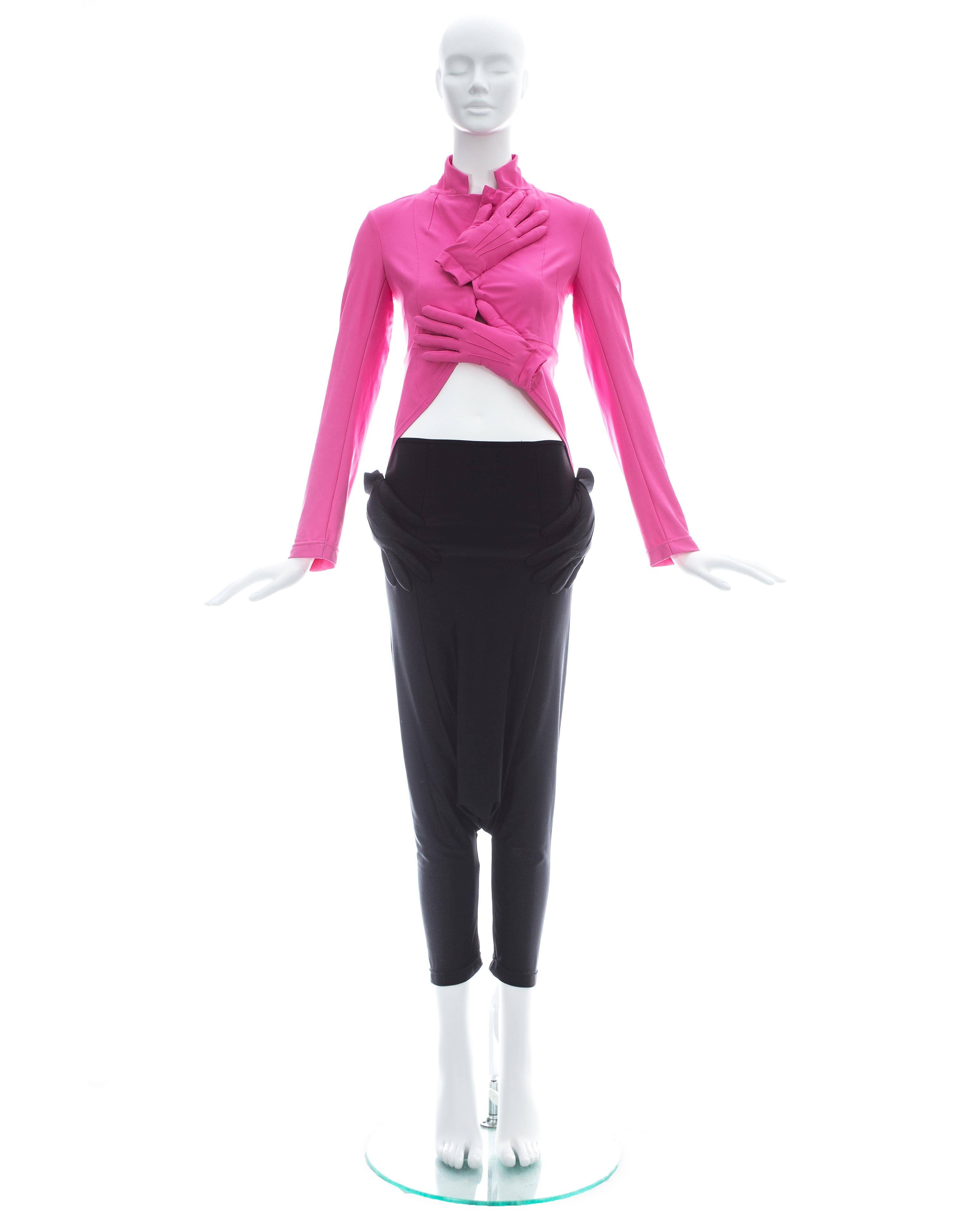 Comme des Garcons; Hot pink lycra fitted jacket matched with a pair of black lycra harem pants; both with attached padded gloves 

Fall-Winter 2007