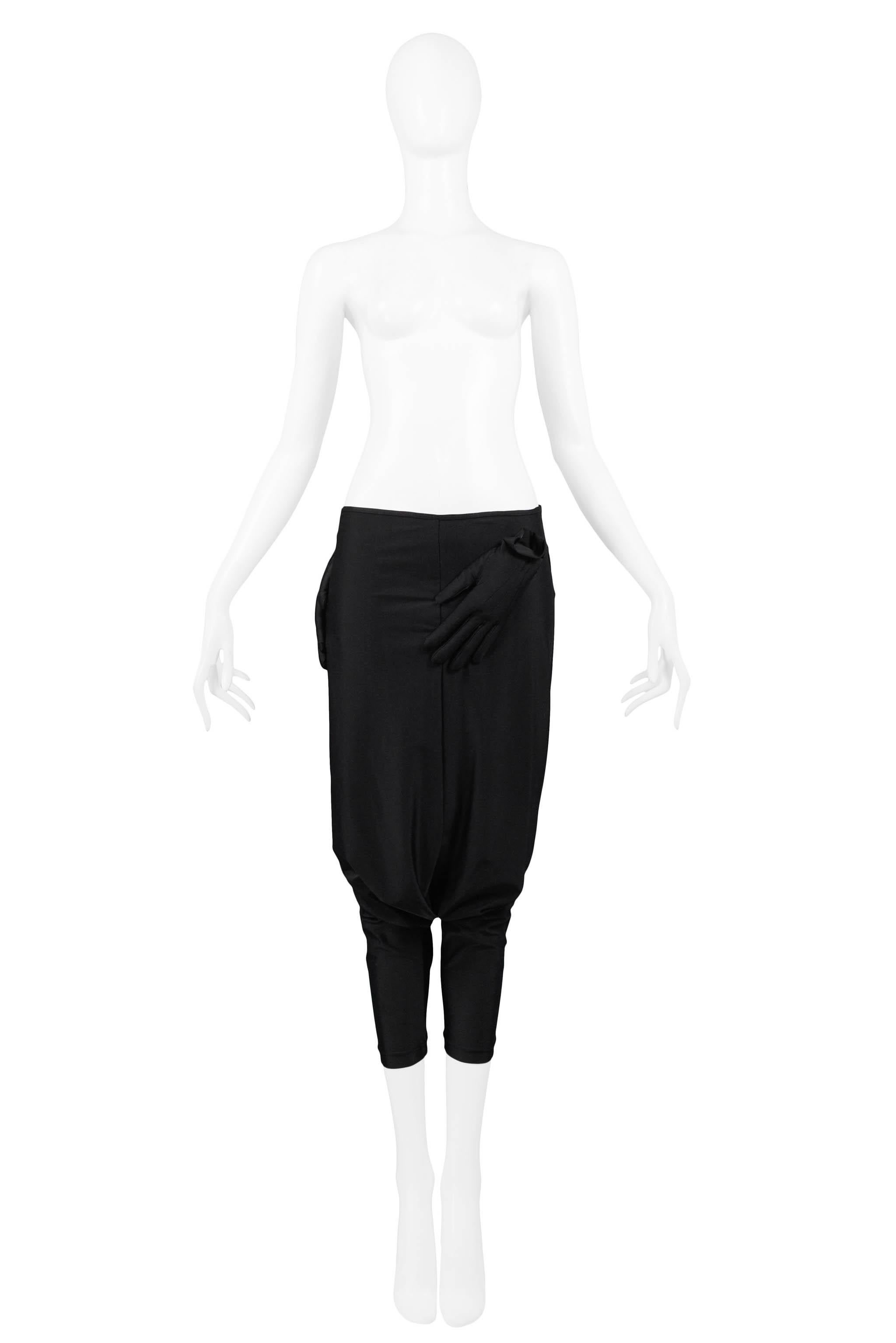 Resurrection Vintage is excited to offer a pair of vintage Comme des Garcons black glove harem pants featuring black padded gloves at the waistband, drop crotch, balloon legs, tight calves, and cropped length.

Size Large
2007 Collection
Stretch