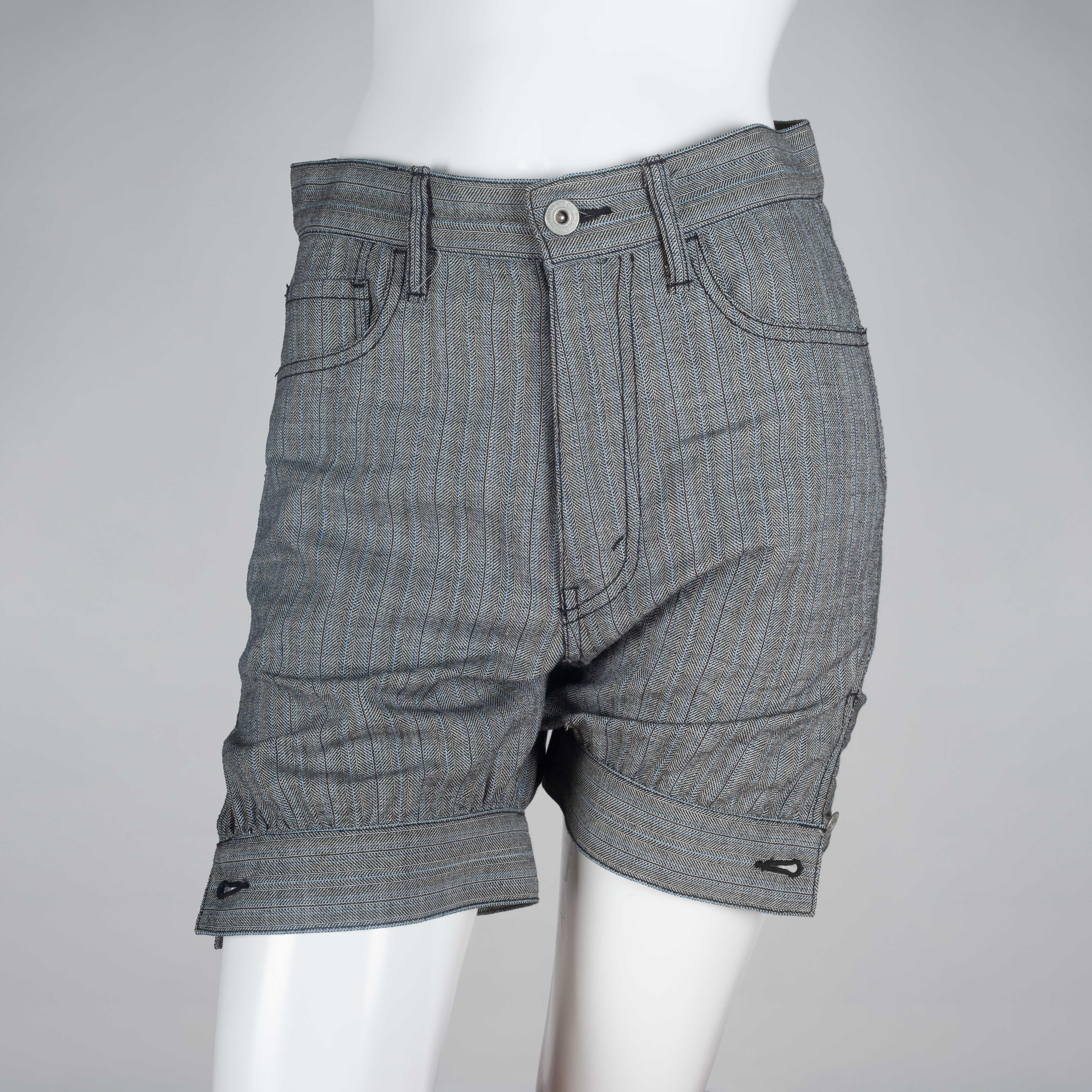 Junya Watanabe Comme des Garçons 2007, gray wool shorts from Japan with pin stripe pattern, dark stitching and tapered, button hem. Super extra small. 

YEAR: 2007
MARKED SIZE: XS
US WOMEN'S: XS
US MEN'S: XXS
FIT: Regular
WAIST: 14