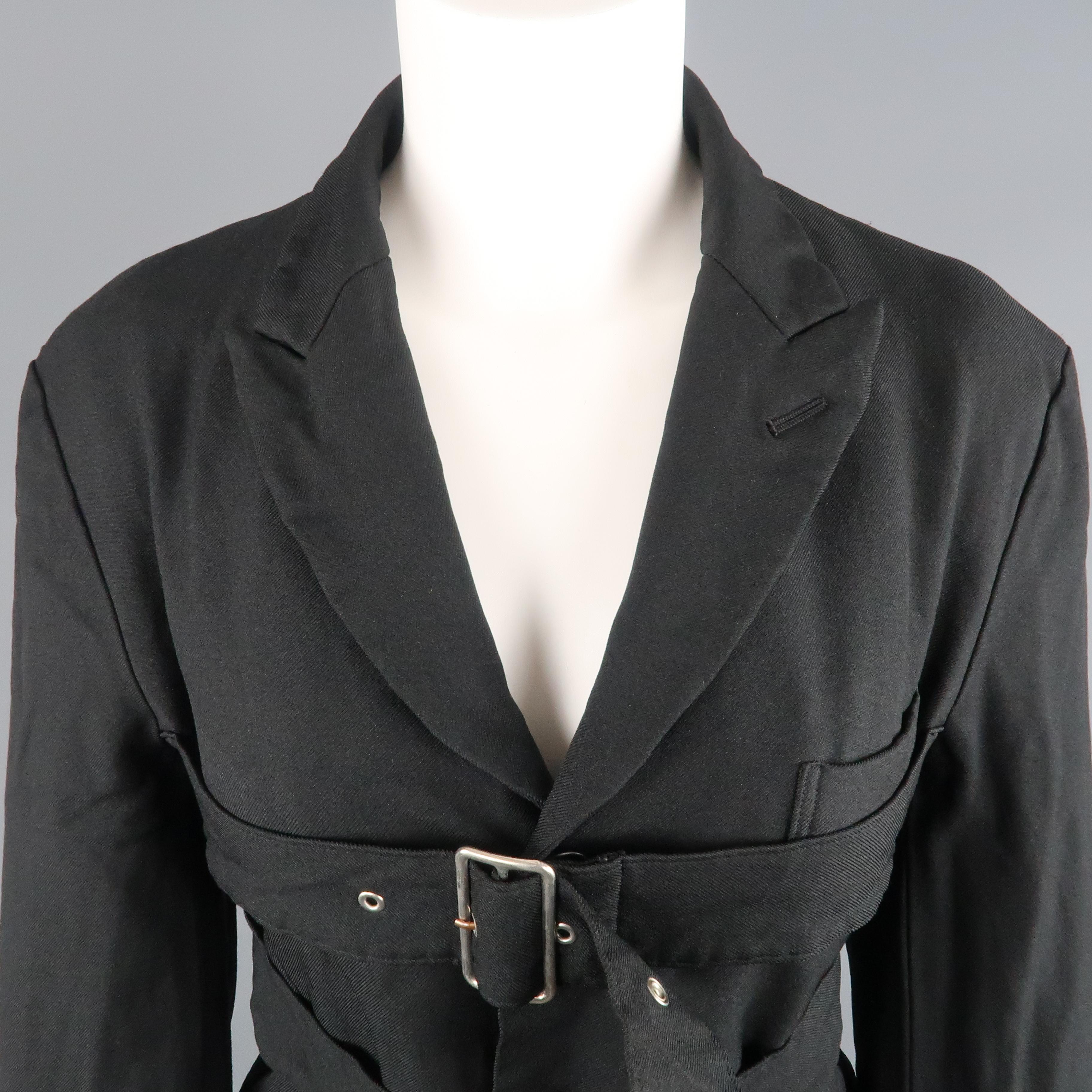 COMME des GARCONS BLACK blazer comes in wrinkle textured polyester twill with a peak lapel, single breasted three button front, functional button cuff sleeves, and double belted front details. Made in Japan.
 
Excellent Pre-Owned Condition.
Marked: