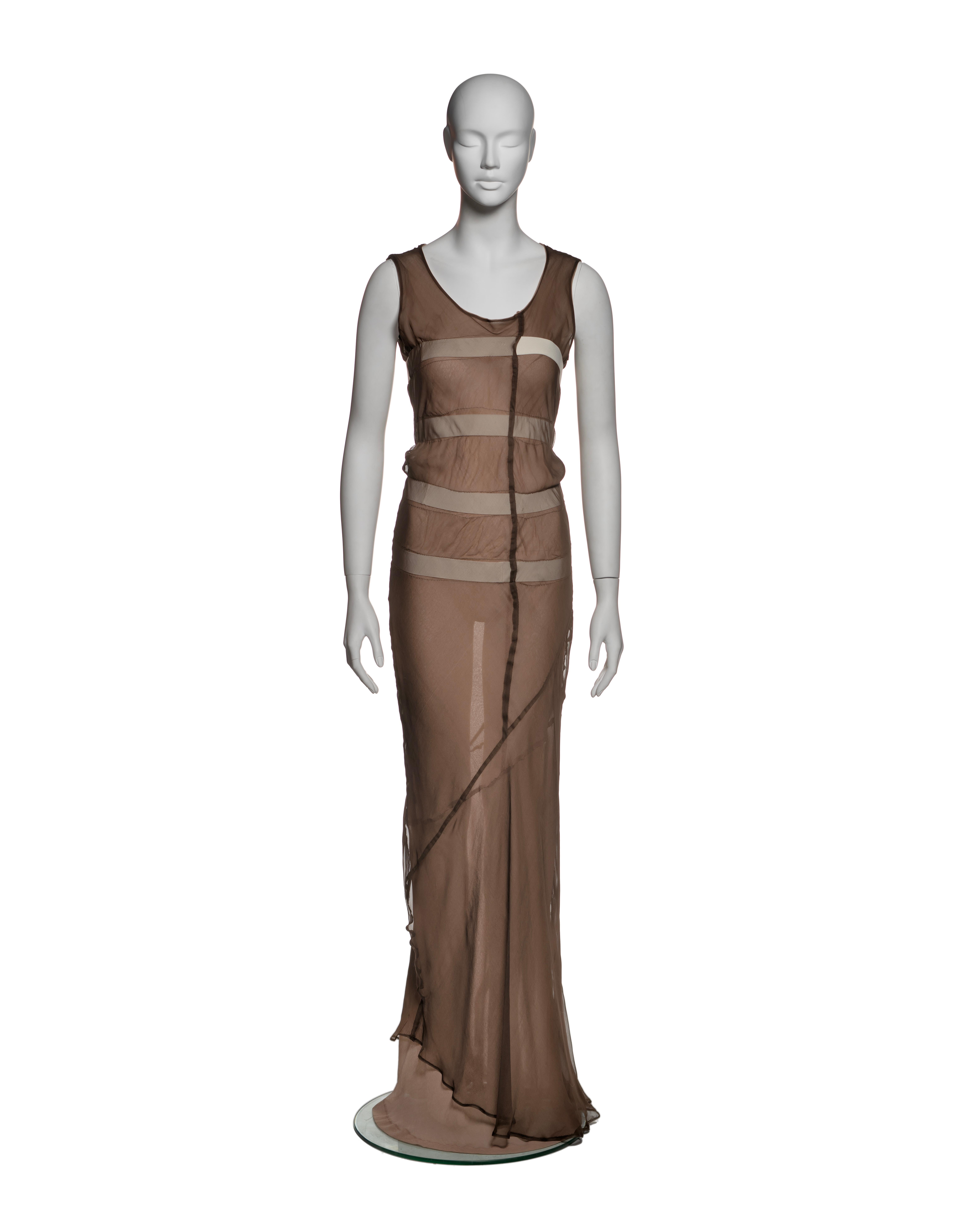This Comme des Garçons dress plays with transparency and layering, offering a minimalist, architectural silhouette typical of Rei Kawakubo's signature design approach in the early 90's. It is constructed from two layers of bias-cut silk chiffon in a