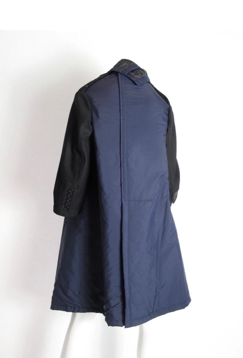 
Comme des Garcons layered coat with two pockets, quilted lining, button closure at front. 40