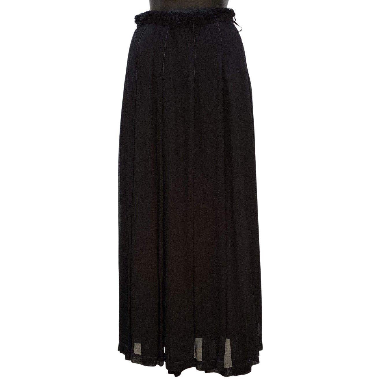 This full, weighty black skirt boasts multiple layers of rayon and cotton joined at the elasticized waist with a side zipper closure. Contrasting purple stitching and intentional fraying at the waist make this vintage skirt a standout. 