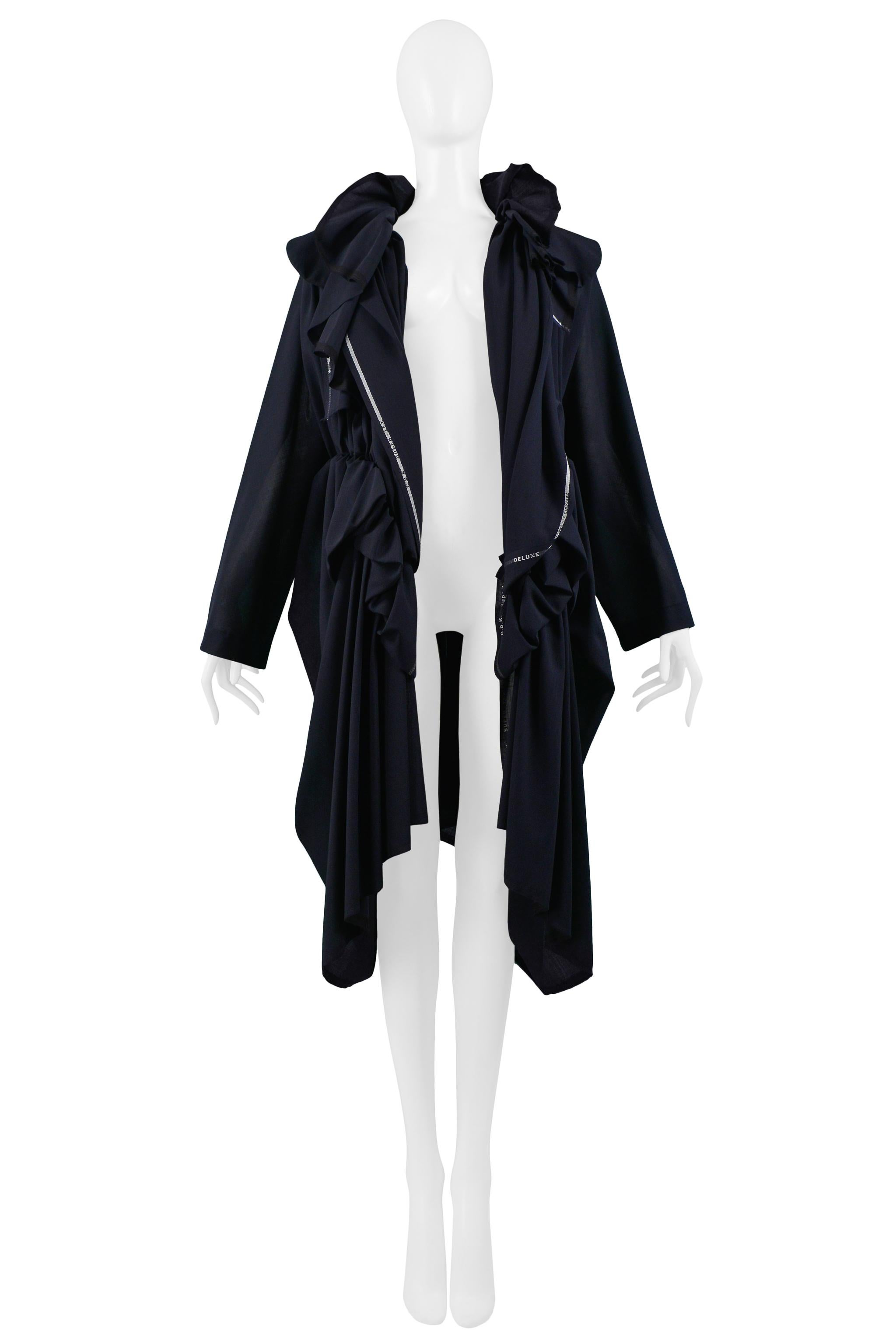 Resurrection Vintage is excited to offer a vintage Comme des Garcons Vintage navy blue deconstructed coat with ruffles at collar and waist, gathers at center back, asymmetrical hemline, and selvage hem throughout. Collection 2005.

Comme Des