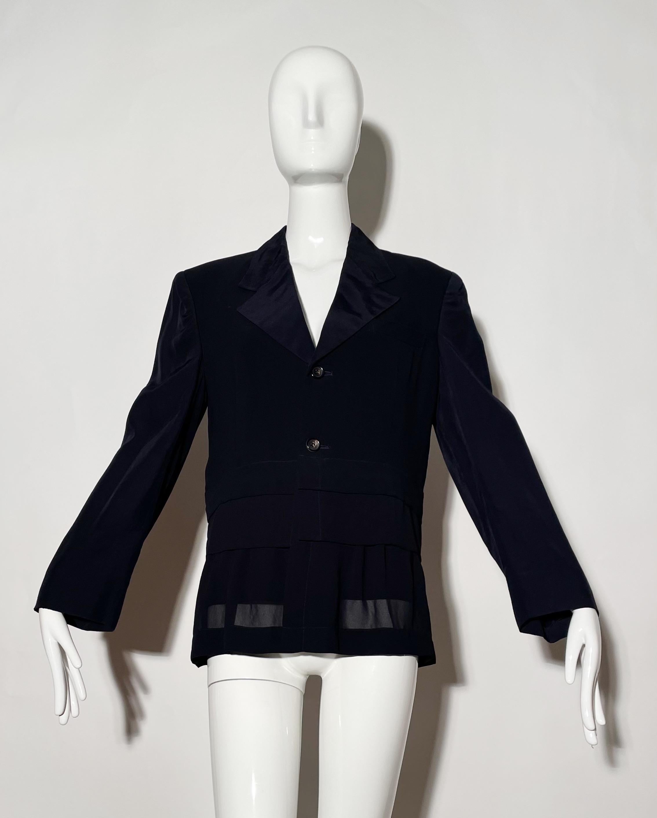 Navy blazer with layered bottom. Front buttons. Nylon and silk. 
*Condition: Excellent vintage condition. No visible Flaws.

Measurements Taken Laying Flat (inches)—
Shoulder to Shoulder: 17 in.
Sleeve Length: 23 in.
Bust: 38 in.
Waist: 34