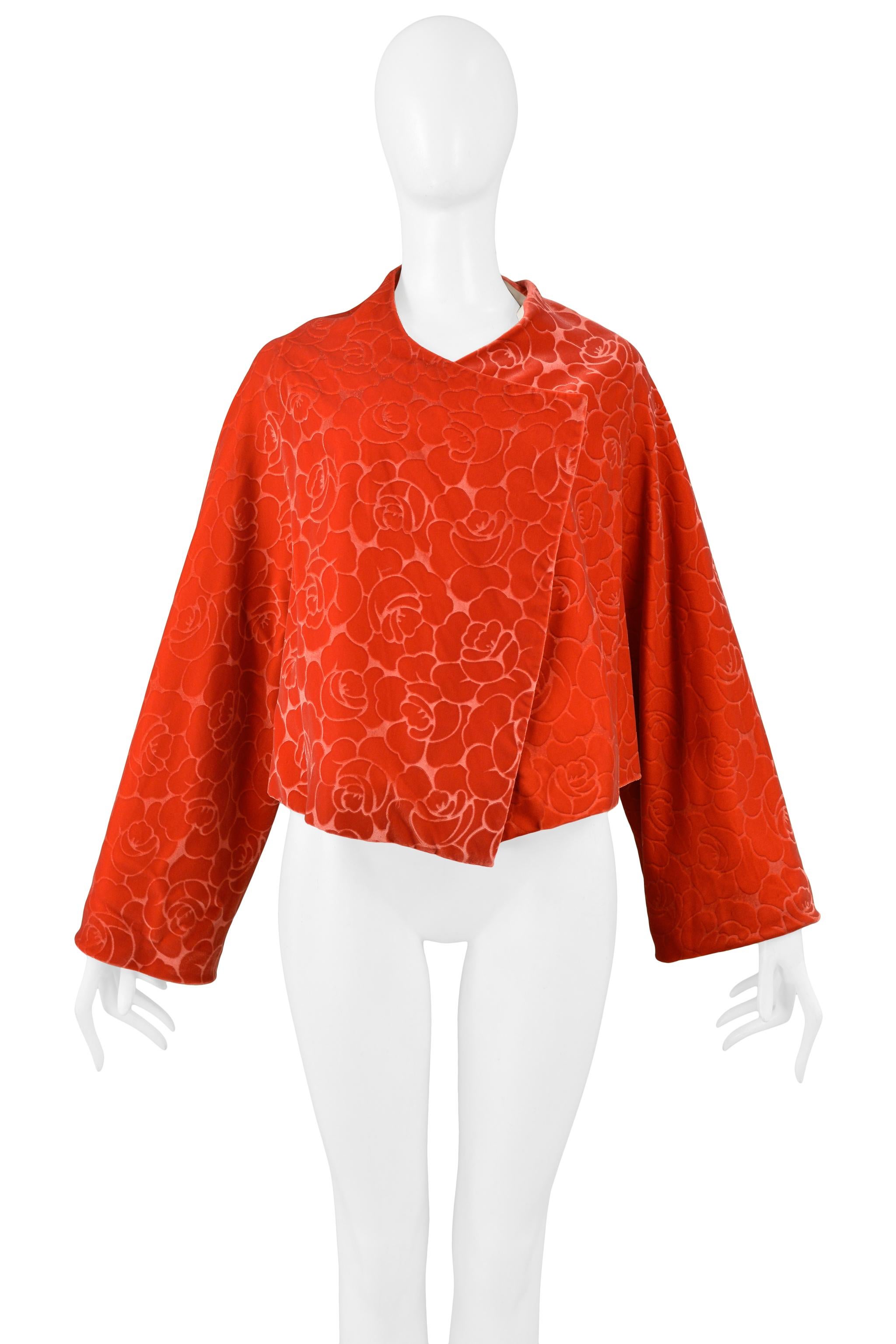 Resurrection Vintage is excited to offer a vintage Comme des Garcons red-orange floral kimono style jacket featuring a trapeze shape body, velvet burnout fabric, extra long sleeves, and natural color muslin lining. From the 1996 collection. 

Comme