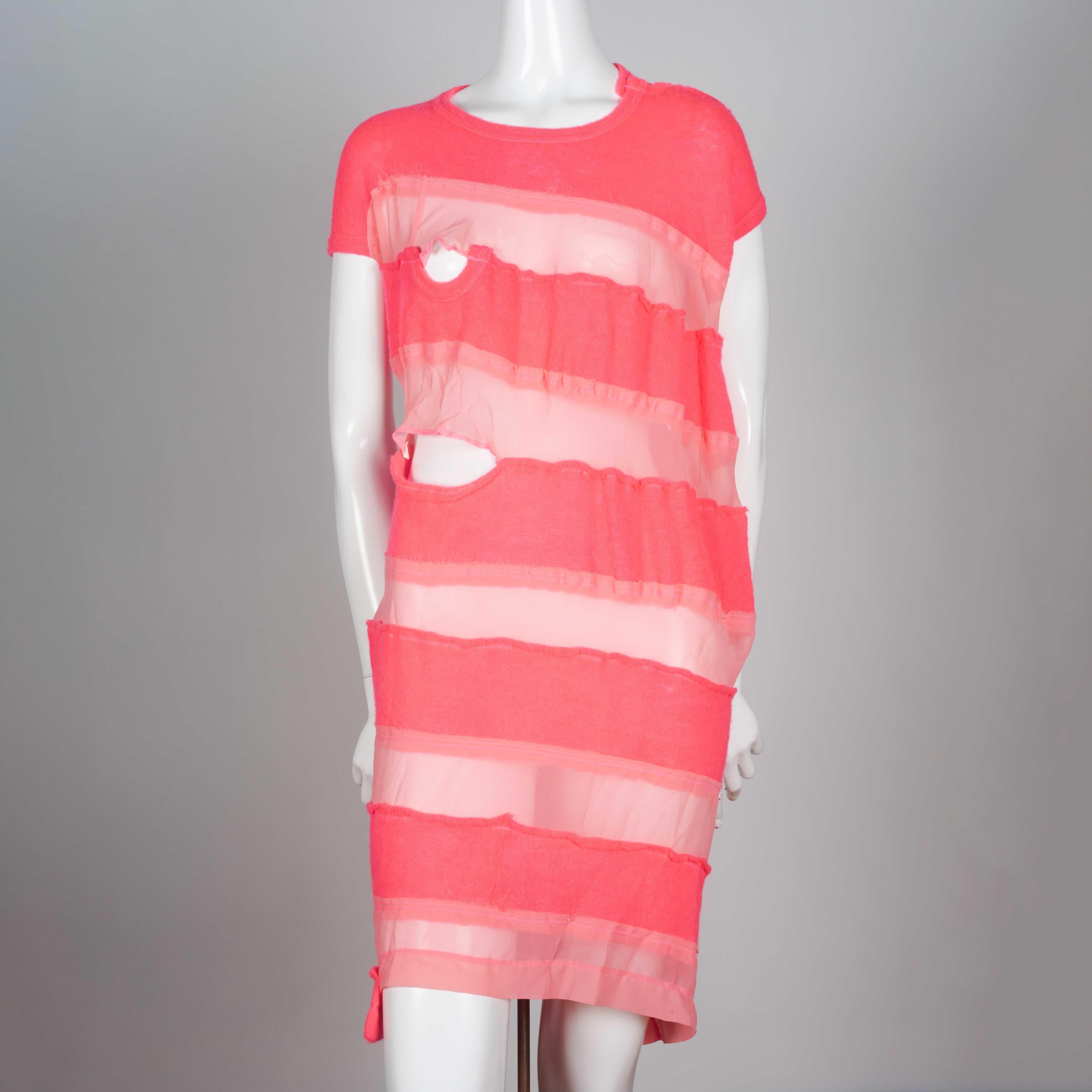 Comme des Garçons Tricot 2013, a neon pink sweater dress with alternating sheer horizontal strips. Asymmetric cut and design imbedded holes in an avant-garde mood. 

YEAR: 2013
MARKED SIZE: M
US WOMEN'S: S
US MEN'S: XS
FIT: Regular
CHEST: 17